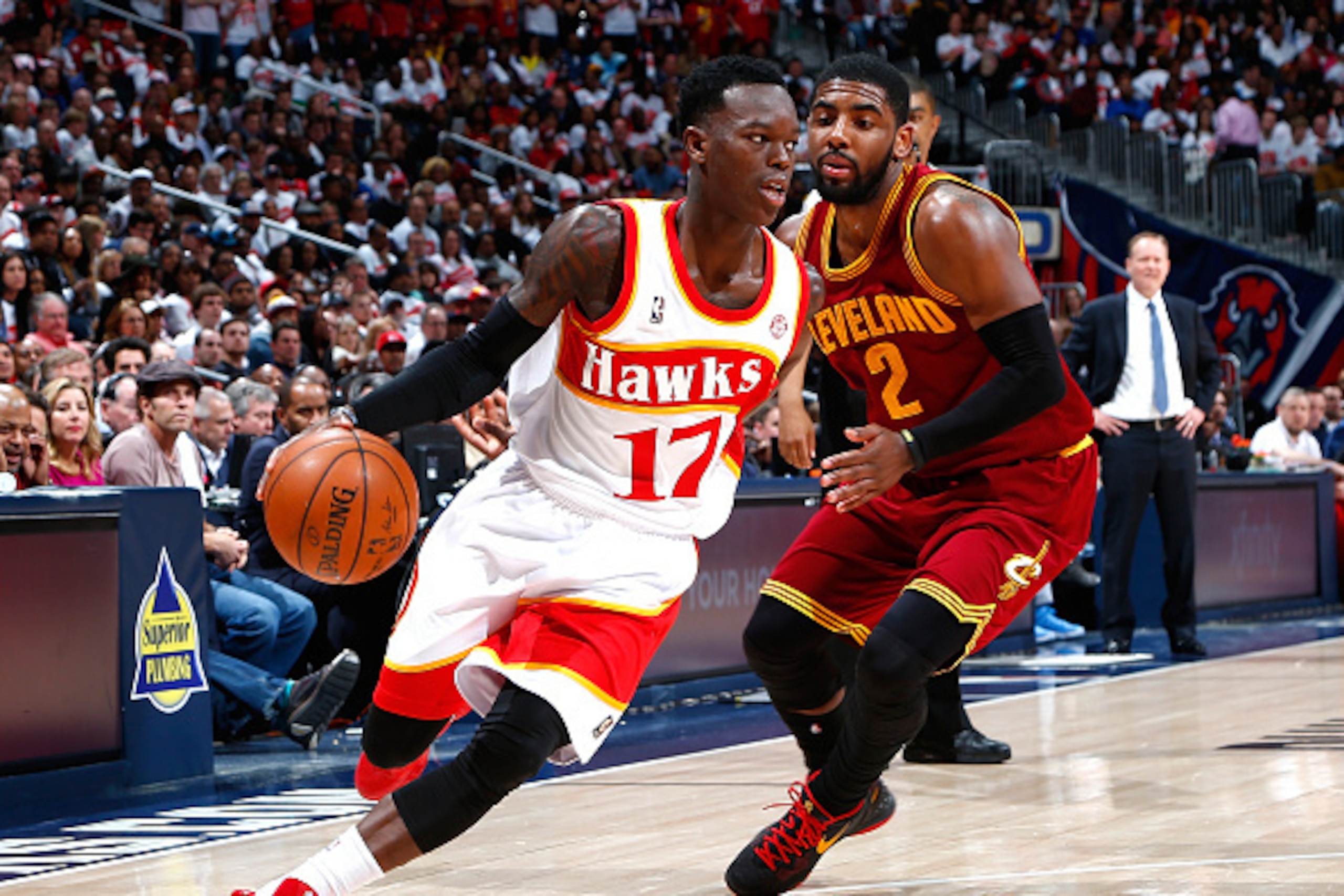 ATLANTA, GA - MARCH 06:  Dennis Schroder #17 of the Atlanta Hawks drives against Kyrie Irving #2 of the Cleveland Cavaliers at Philips Arena on March 6, 2015 in Atlanta, Georgia.  NOTE TO USER: User expressly acknowledges and agrees that, by downloading a