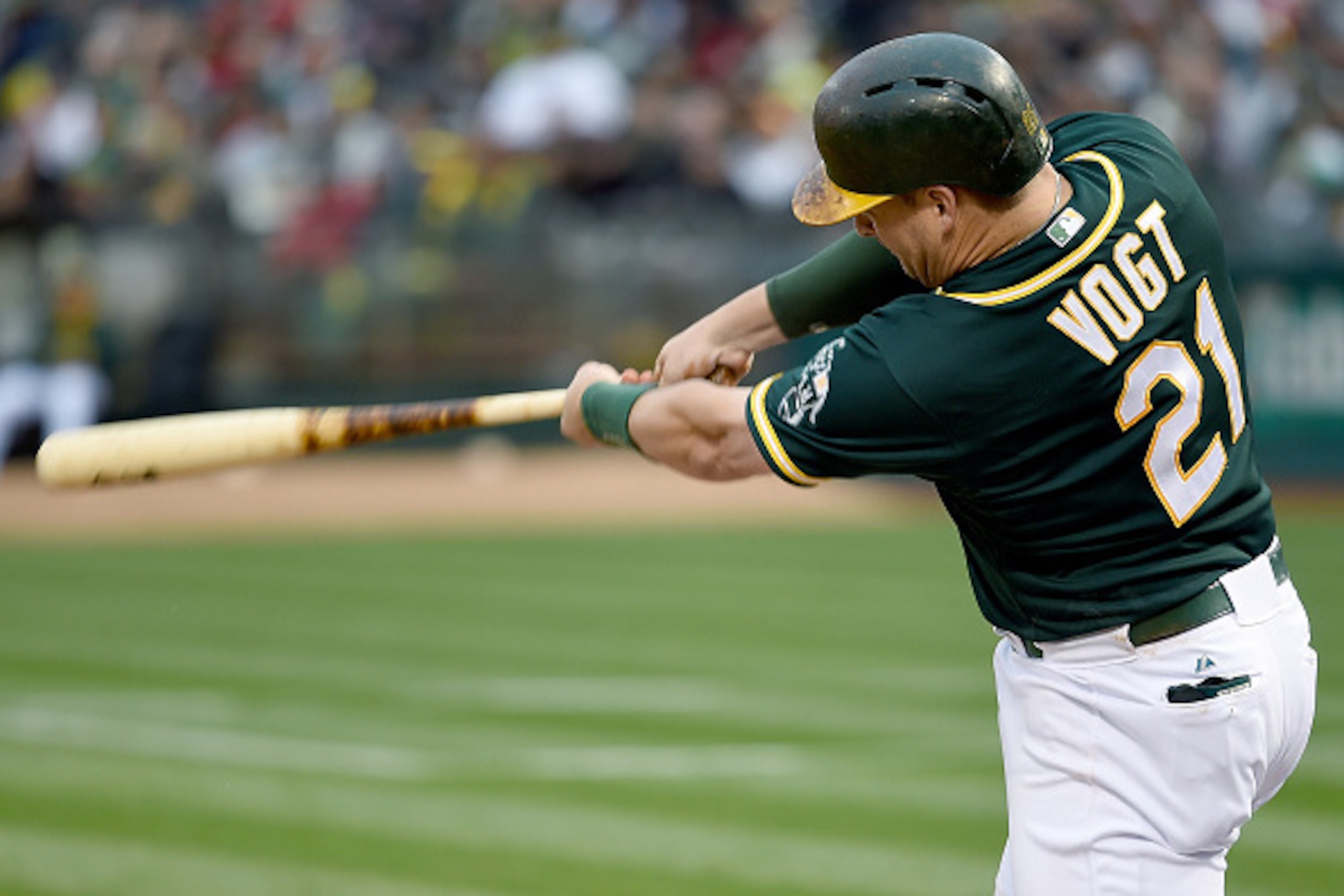 OAKLAND, CA - MAY 12:  Stephen Vogt #21 of the Oakland Athletics hits a two-run homer against the Boston Red Sox in the bottom of the first inning at O.co Coliseum on May 12, 2015 in Oakland, California.  (Photo by Thearon W. Henderson/Getty Images)
