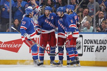 NEW YORK, NY - MAY 16:  Derek Stepan #21 of the New York Rangers celebrates his second period goal with Dan Girardi #5, Jesper Fast #19 and Ryan McDonagh #27 against the Tampa Bay Lightning in Game One of the Eastern Conference Final during the 2015 NHL S