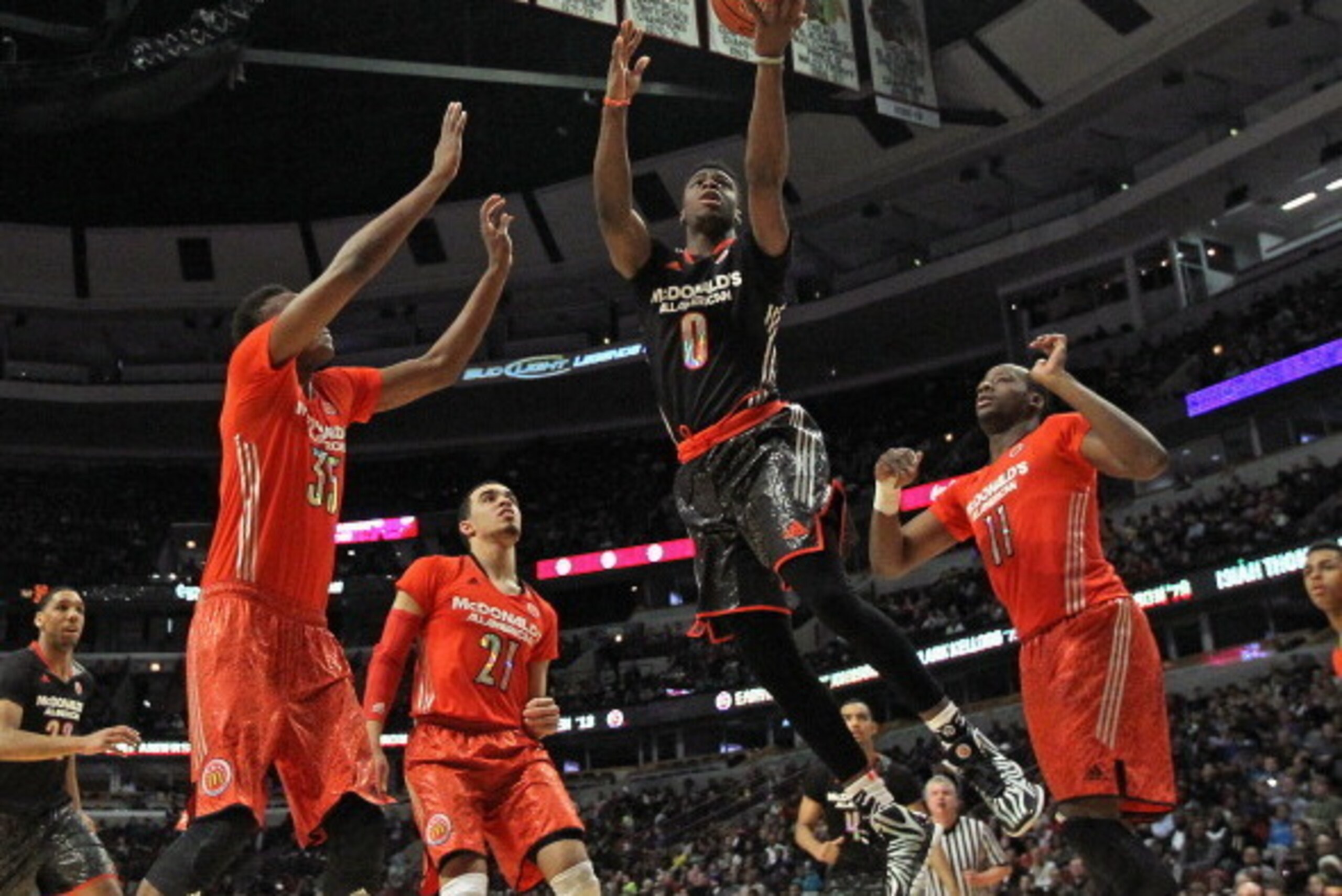 CHICAGO, IL - APRIL 02:  Emmanuel Mudiay #0 of the west team goes up for a shot between (L-R) Myles Turner #35, Tyus Jones #21 and Cliff Alexander #11 of the east team during the 2014 McDonald's All American Game at United Center on April 2, 2014 in Chica