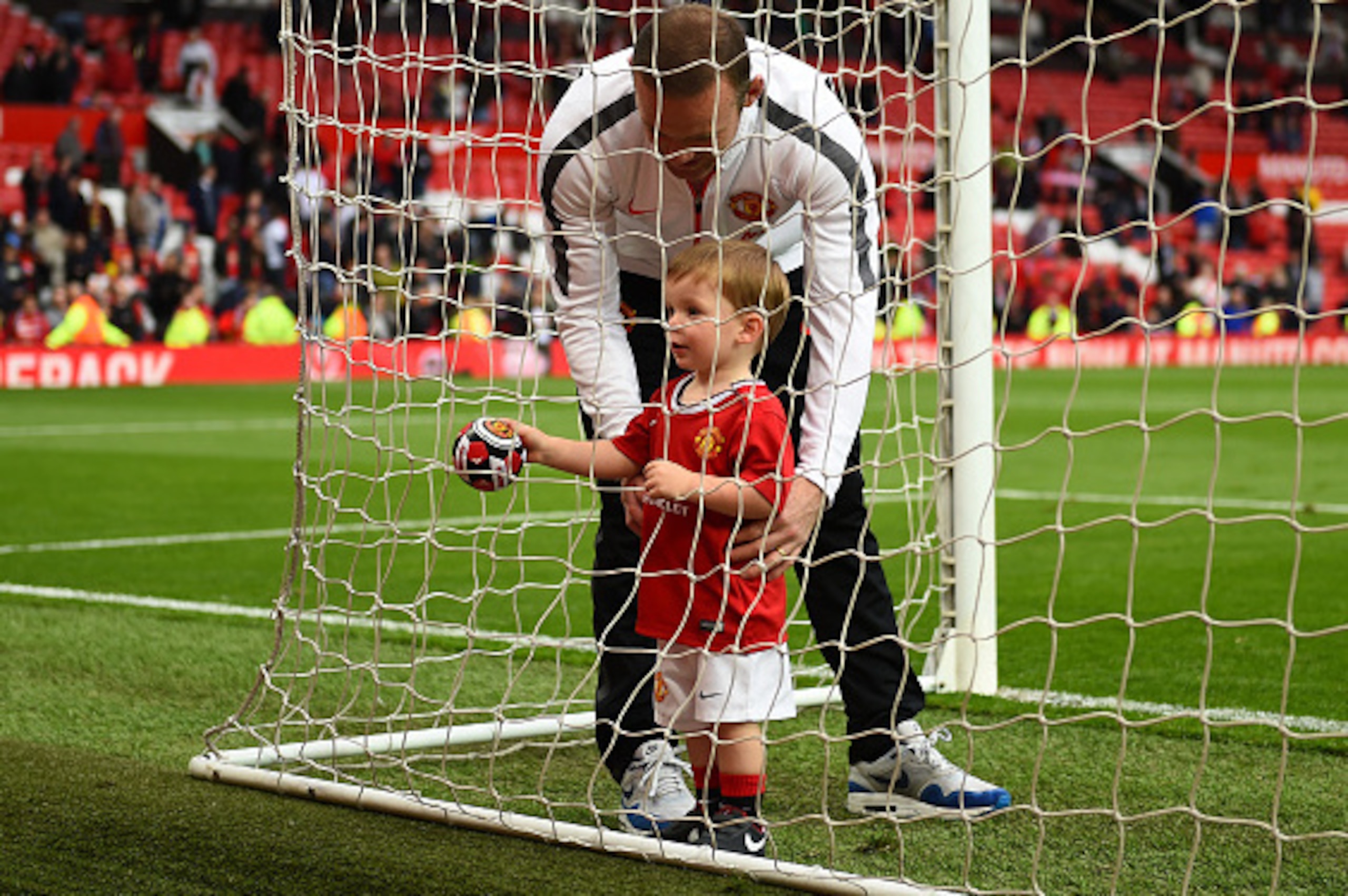 MANCHESTER, ENGLAND - MAY 17:  Wayne Rooney of Manchester United and son Klay play in the goal after the Barclays Premier League match between Manchester United and Arsenal at Old Trafford on May 17, 2015 in Manchester, England.  (Photo by Shaun Botterill
