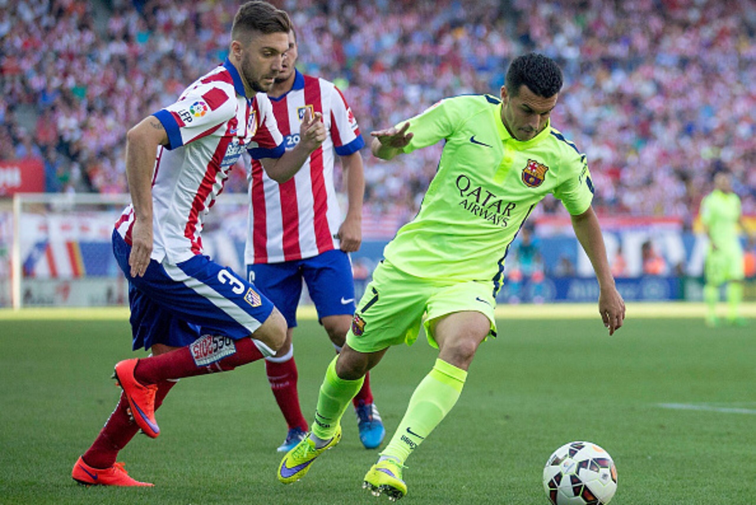 MADRID, SPAIN - MAY 17: Pedro of Barcelona holds off Guilherme Siqueira of Atletico MadrArsene Wenger manager of Arsenal during the La Liga match between Club Atletico de Madrid and FC Barcelona at Vicente Calderon Stadium on May 17, 2015 in Madrid, Spain