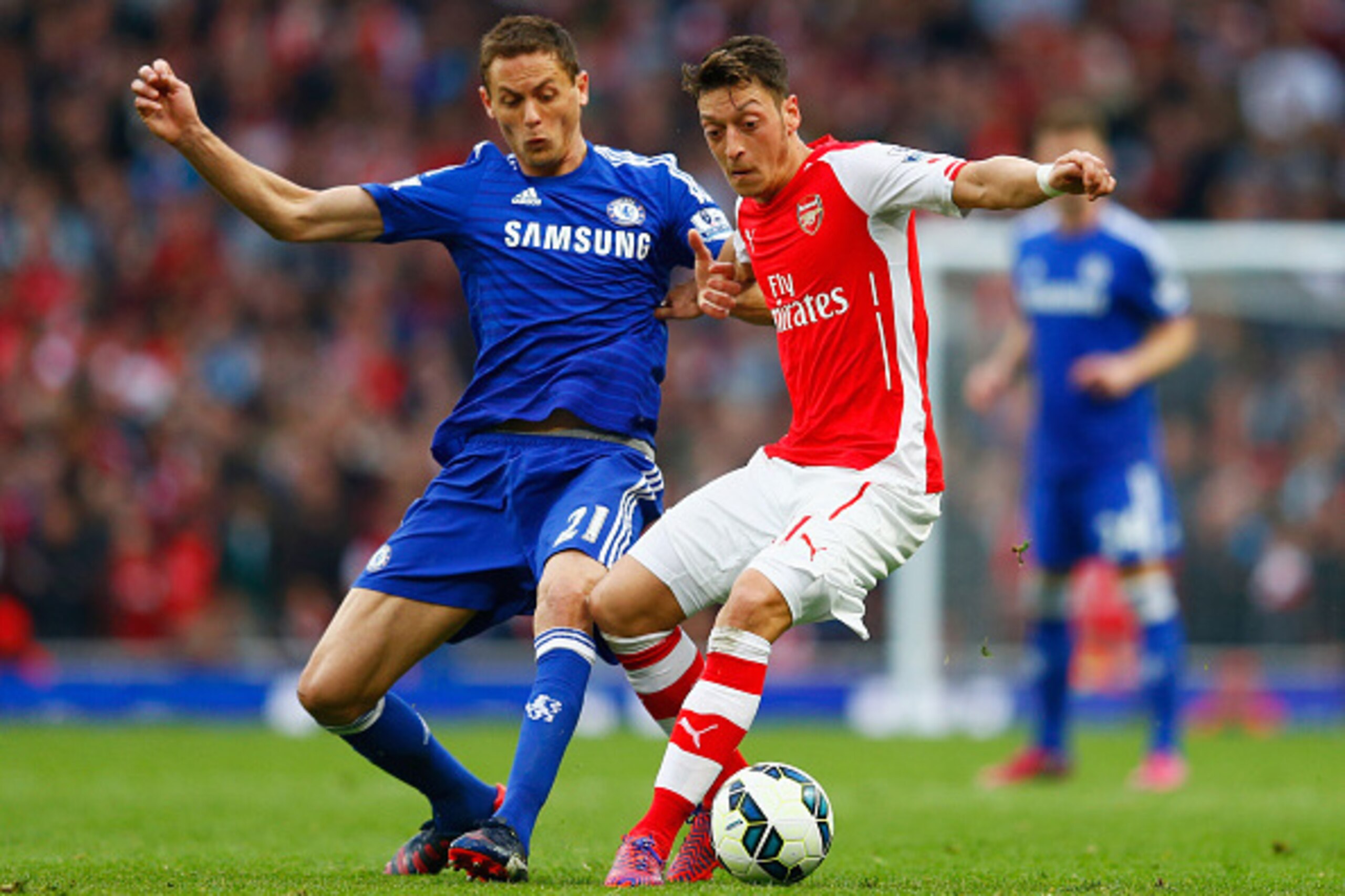 LONDON, ENGLAND - APRIL 26:  Mesut Oezil of Arsenal holds off Nemanja Matic of Chelsea during the Barclays Premier League match between Arsenal and Chelsea at Emirates Stadium on April 26, 2015 in London, England.  (Photo by Julian Finney/Getty Images)