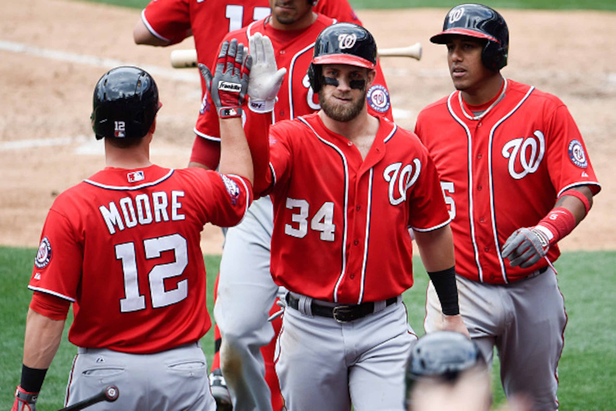 SAN DIEGO, CA - MAY 17: Bryce Harper #34 of the Washington Nationals is congratulated by Tyler Moore #12 and Yunel Escobar #5 after he hit a three-run home run during the seventh inning of a baseball game against the San Diego Padres at Petco Park May 17 SAN DIEGO, CA - MAY 17: Bryce Harper #34 of the Washington Nationals is congratulated by Tyler Moore #12 and Yunel Escobar #5 after he hit a three-run home run during the seventh inning of a baseball game against the San Diego Padres at Petco Park May 17
