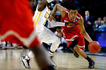 PORTLAND, OR - MARCH 19:  D'Angelo Russell #0 of the Ohio State Buckeyes dribbles past JeQuan Lewis #1 of the Virginia Commonwealth Rams in the first half during the second round of the 2015 NCAA Men's Basketball Tournament at Moda Center on March 19, 201