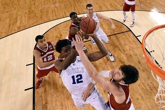 INDIANAPOLIS, IN - APRIL 06: Justise Winslow #12 of the Duke Blue Devils drives to the basket against Frank Kaminsky #44 of the Wisconsin Badgers in the first half during the NCAA Men's Final Four National Championship at Lucas Oil Stadium on April 6, 201