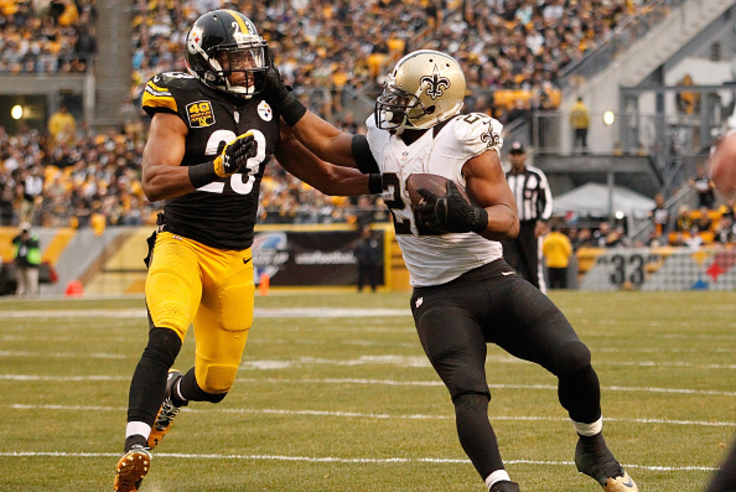 PITTSBURGH, PA - NOVEMBER 30:  Mark Ingram #22 of the New Orleans Saints stiff arms Mike Mitchell #23 of the Pittsburgh Steelers during the fourth quarter at Heinz Field on November 30, 2014 in Pittsburgh, Pennsylvania.  (Photo by Justin K. Aller/Getty Im