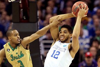 CLEVELAND, OH - MARCH 28: V.J. Beachem #3 of the Notre Dame Fighting Irish defends Karl-Anthony Towns #12 of the Kentucky Wildcats in the first half during the Midwest Regional Final of the 2015 NCAA Men's Basketball tournament at Quicken Loans Arena on M