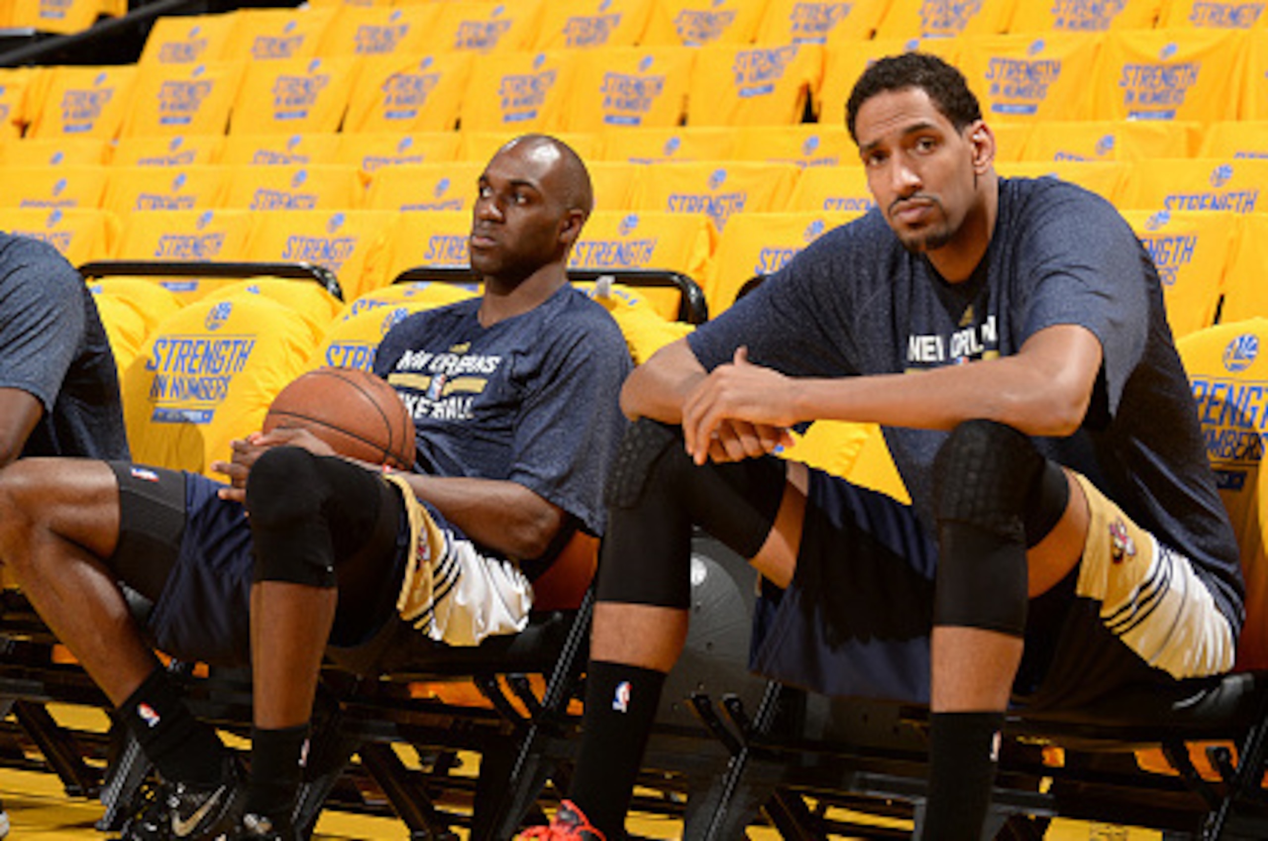 OAKLAND, CA - APRIL 20:  Eric Gordon #10, Quincy Pondexter #20 and Alexis Ajinca #42 of the New Orleans Pelicans sit on the bench before Game Two of the Western Conference Quarterfinals against the Golden State Warriors during the NBA Playoffs on April 20