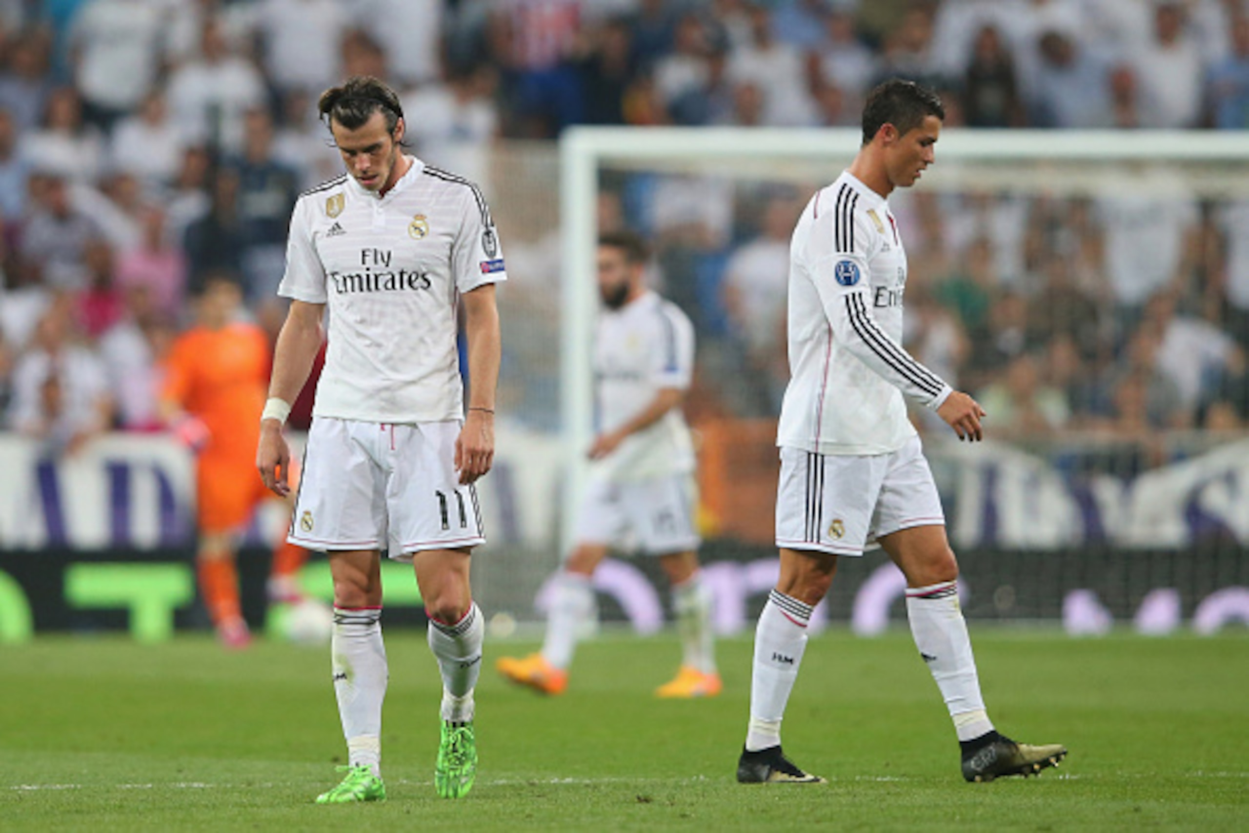MADRID, SPAIN - MAY 13:  (L-R) Dejected Real Madrid teammates Gareth Bale and Cristiano Ronaldo walk off the pitch following their team's exit from the competition during the UEFA Champions League Semi Final, second leg match between Real Madrid and Juven