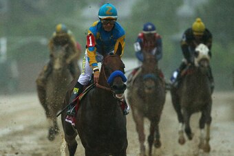 BALTIMORE, MD - MAY 16:  American Pharoah #1 ridden by Victor Espinoza crosses the finish line to win the 140th running of the Preakness Stakes at Pimlico Race Course on May 16, 2015 in Baltimore, Maryland.  (Photo by Patrick Smith/Getty Images)