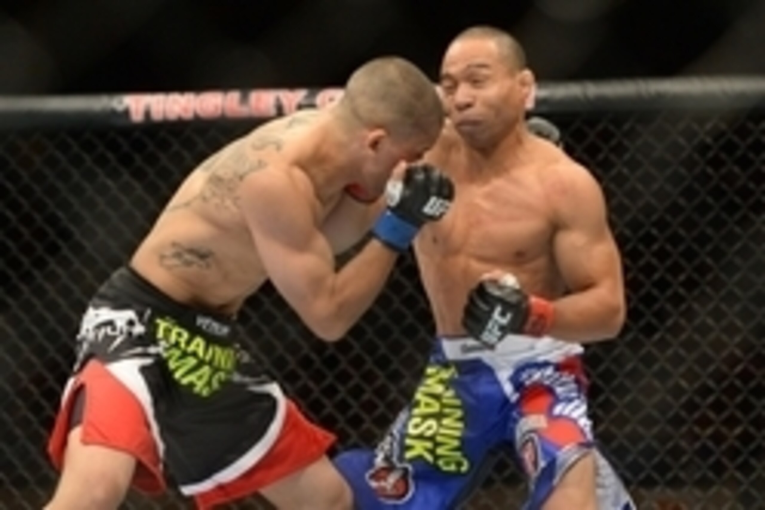 Jun 7, 2014; Albuquerque, NM, USA; John Dodson (red) and John Moraga (blue) fight during their flyweight bout during UFC Fight Night 42 at Tingley Coliseum. Dodson won after a doctor's stoppage at the end of round two. Mandatory Credit: Joe Camporeale-USA