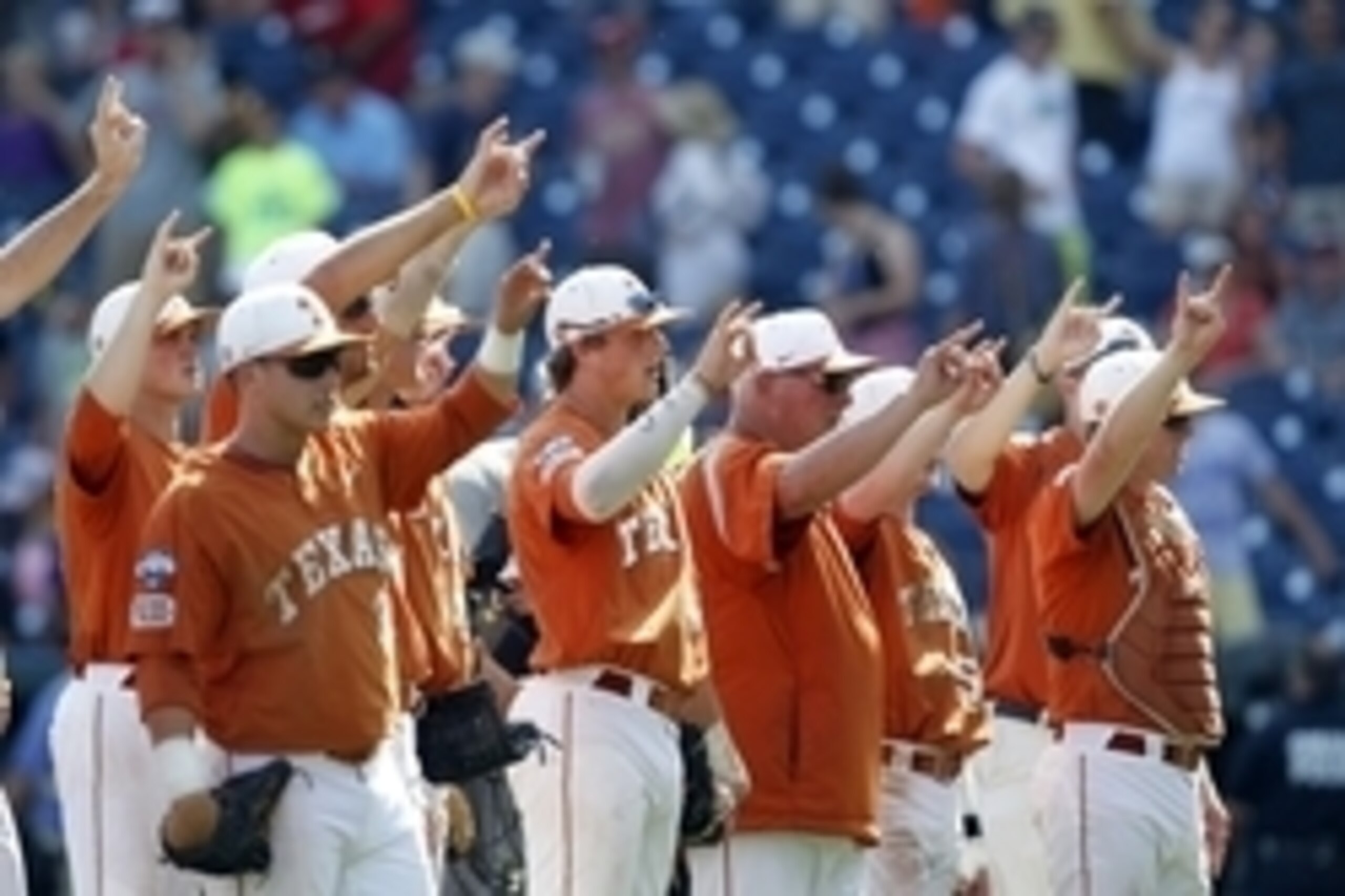 Jun 20, 2014; Omaha, NE, USA; Texas Longhorns head coach Augie Garrido (16) and his players display the
