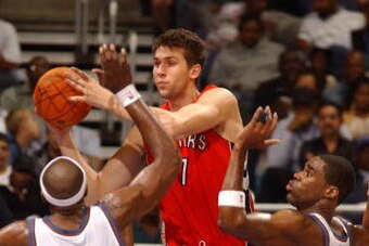WASHINGTON - OCTOBER 9:  Andrea Bargnani #7 of the Toronto Raptors tries a to pass the ball against Brendan Haywood #33 and Antawn Jamison #4 of the Washington Wizards in an NBA basketball exhibition game on October 9, 2006 at the Verizon Center in Washin