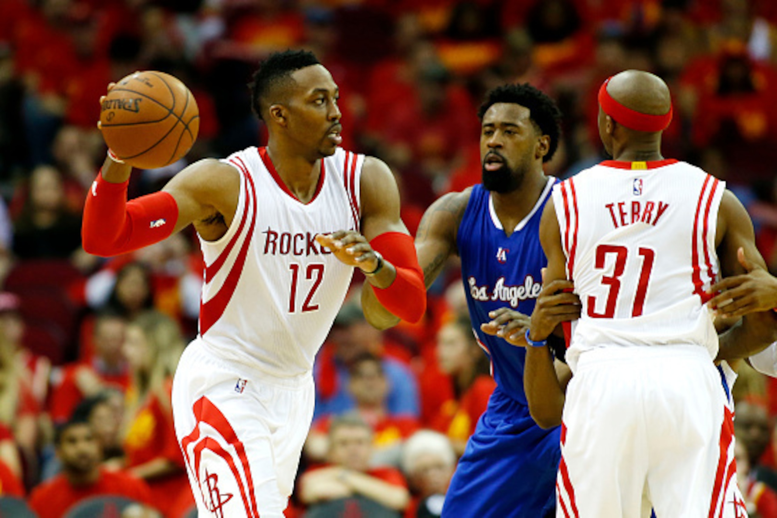 HOUSTON, TX - MAY 17:  Dwight Howard #12 of the Houston Rockets looks to pass against the DeAndre Jordan #6 of the Los Angeles Clippers in the third quarter during Game Seven of the Western Conference Semifinals at the Toyota Center for the 2015 NBA Playo