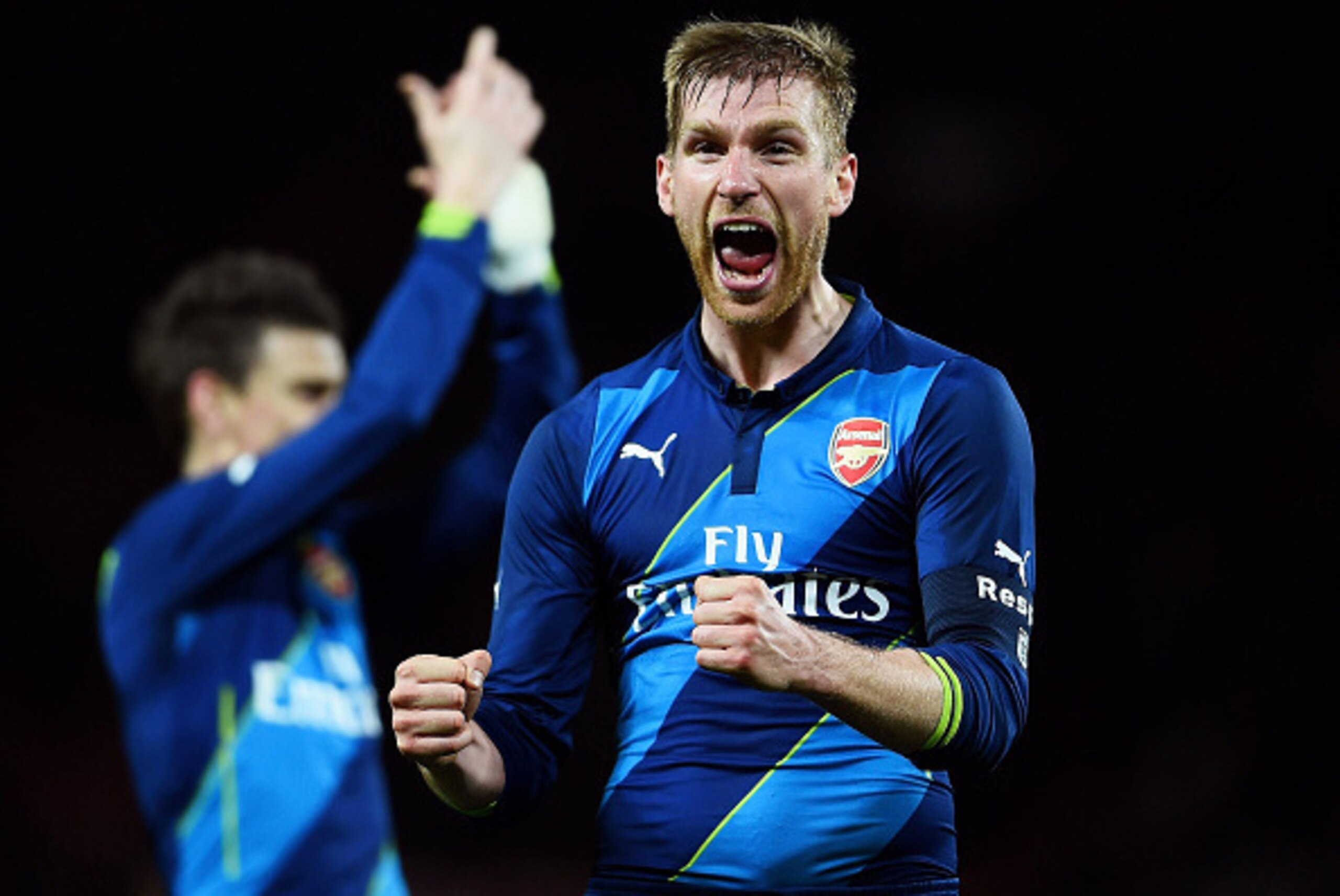 MANCHESTER, ENGLAND - MARCH 09:  Per Mertesacker of Arsenal celebrates following his  team's 2-1 victory during the FA Cup Quarter Final match between Manchester United and Arsenal at Old Trafford on March 9, 2015 in Manchester, England.  (Photo by Lauren