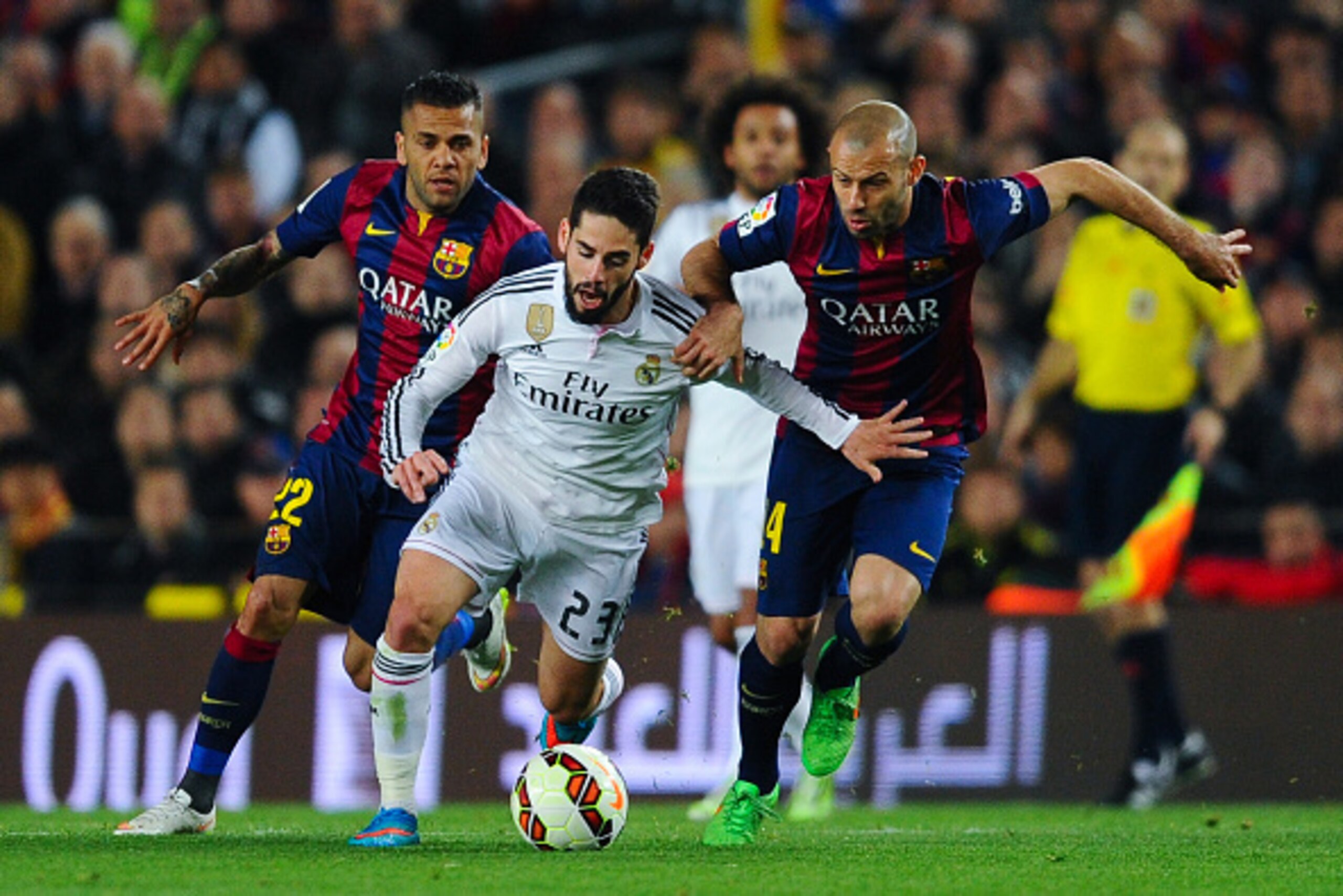 BARCELONA, SPAIN - MARCH 22: Francisco Alarcon Isco of Real Madrid CF competes for the ball with Dani Alves (L) and Javier Mascherano of FC Barcelona during the La Liga match Between FC Barcelona and Real Madrid CF at Camp Nou on March 22, 2015 in Barcelo
