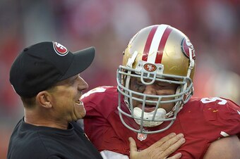 SANTA CLARA, CA - NOVEMBER 23: Head coach Jim Harbaugh of the San Francisco 49ers celebrates with Justin Smith #94 after a forced fumble in the fourth quarter against the Washington Redskins at Levi's Stadium on November 23, 2014 in Santa Clara, Californi
