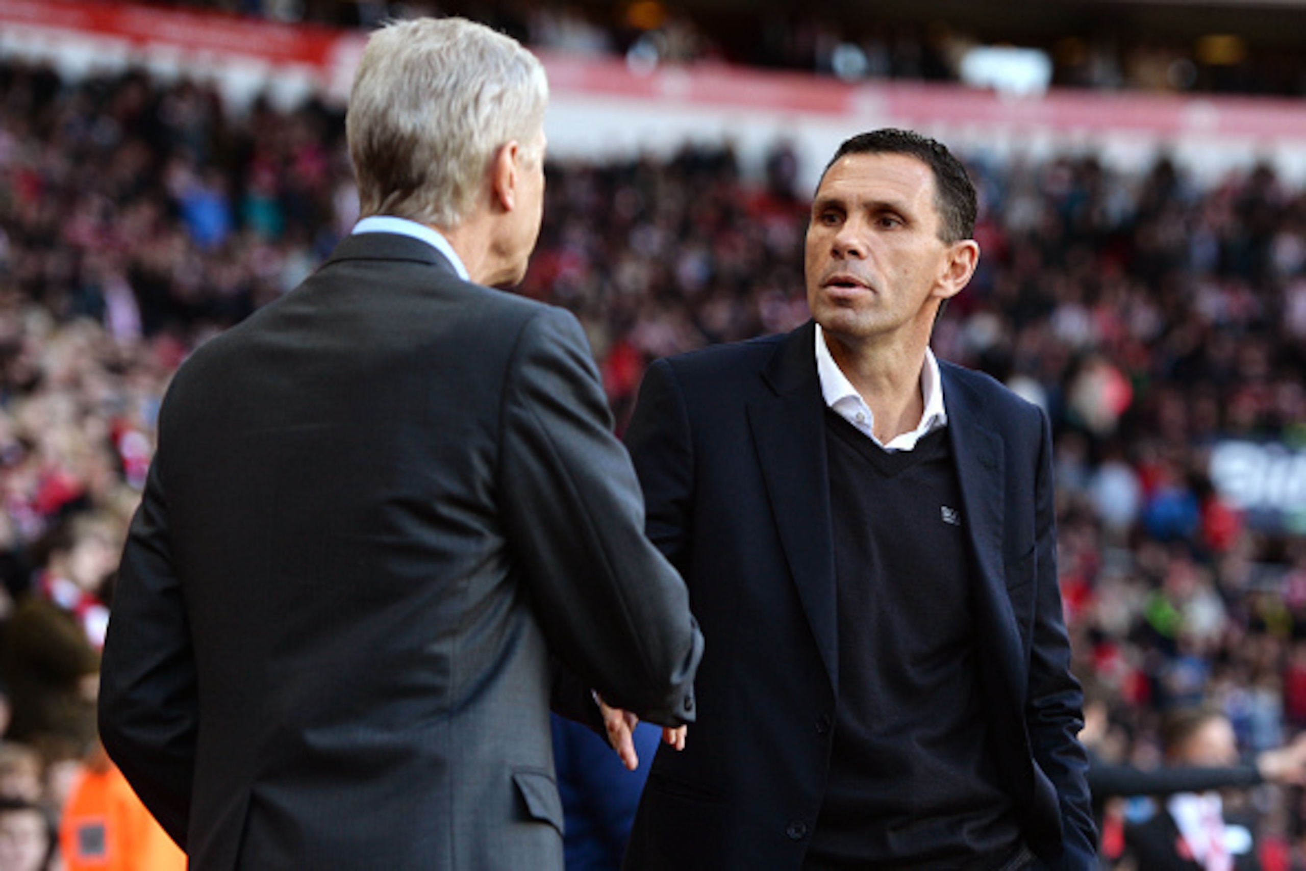 SUNDERLAND, ENGLAND - OCTOBER 25:  (L-R) Arsene Wenger, manager of Arsenal greets Manager Gustavo Poyet of Sunderland  prior to kickoff during the Barclays Premier League match between Sunderland and Arsenal at the Stadium of Light on October 25, 2014 in 
