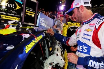 CHARLOTTE, NC - MAY 25:  Jimmie Johnson, driver of the #48 Lowe's Patriotic Chevrolet, places the winner's decal on his car after winning the NASCAR Sprint Cup Series Coca-Cola 600 at Charlotte Motor Speedway on May 25, 2014 in Charlotte, North Carolina. 