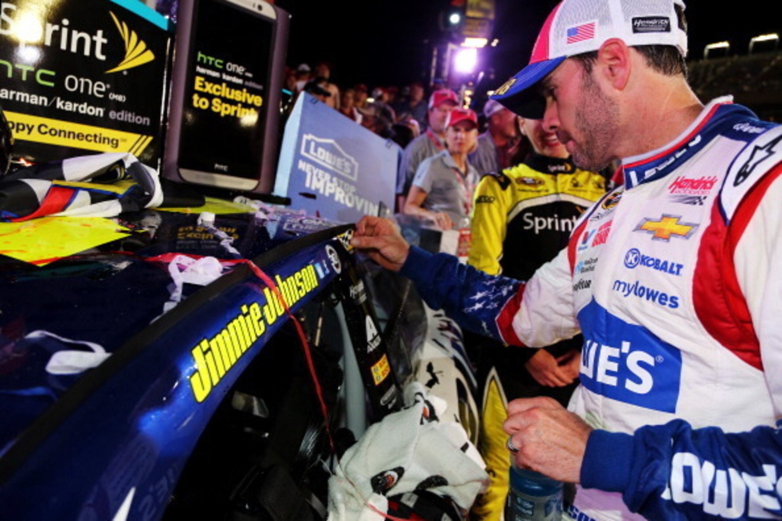 CHARLOTTE, NC - MAY 25:  Jimmie Johnson, driver of the #48 Lowe's Patriotic Chevrolet, places the winner's decal on his car after winning the NASCAR Sprint Cup Series Coca-Cola 600 at Charlotte Motor Speedway on May 25, 2014 in Charlotte, North Carolina. 