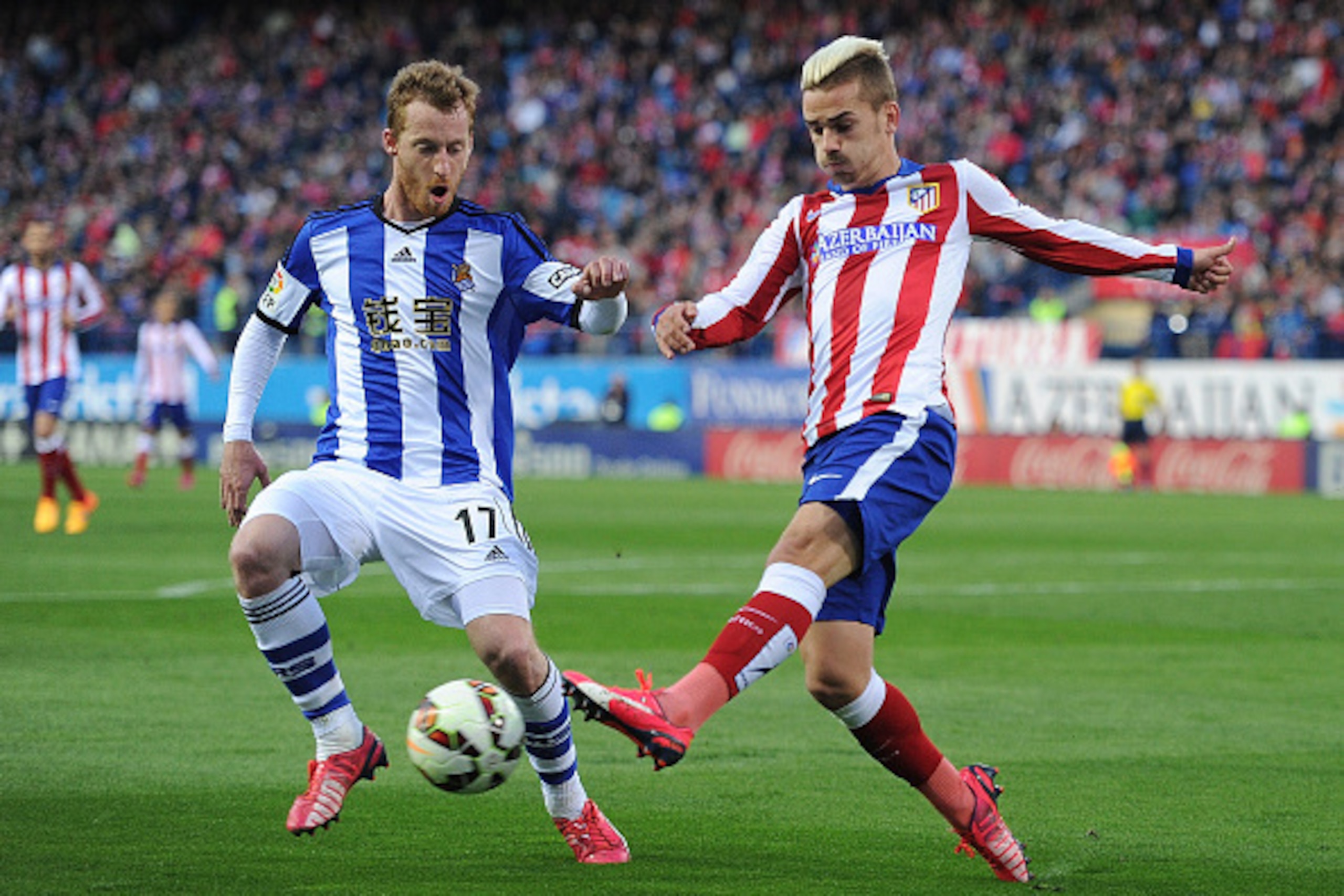 MADRID, SPAIN - APRIL 07:   Antoine Griezmann of Club Atletico de Madrid
is tackled by David Zurutuza of Real Sociedad during the La Liga match between Club Atletico de Madrid and Real Sociedad at Vicente Calderon Stadium on April 7, 2015 in Madrid, Spain