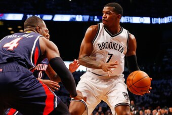 NEW YORK, NY - MAY 01:  Joe Johnson #7 of the Brooklyn Nets looks to make a play as he is defended by Paul Millsap #4 and Jeff Teague #0 of the Atlanta Hawks during game six in the first round of the 2015 NBA Playoffs at Barclays Center on May 1, 2015 in 