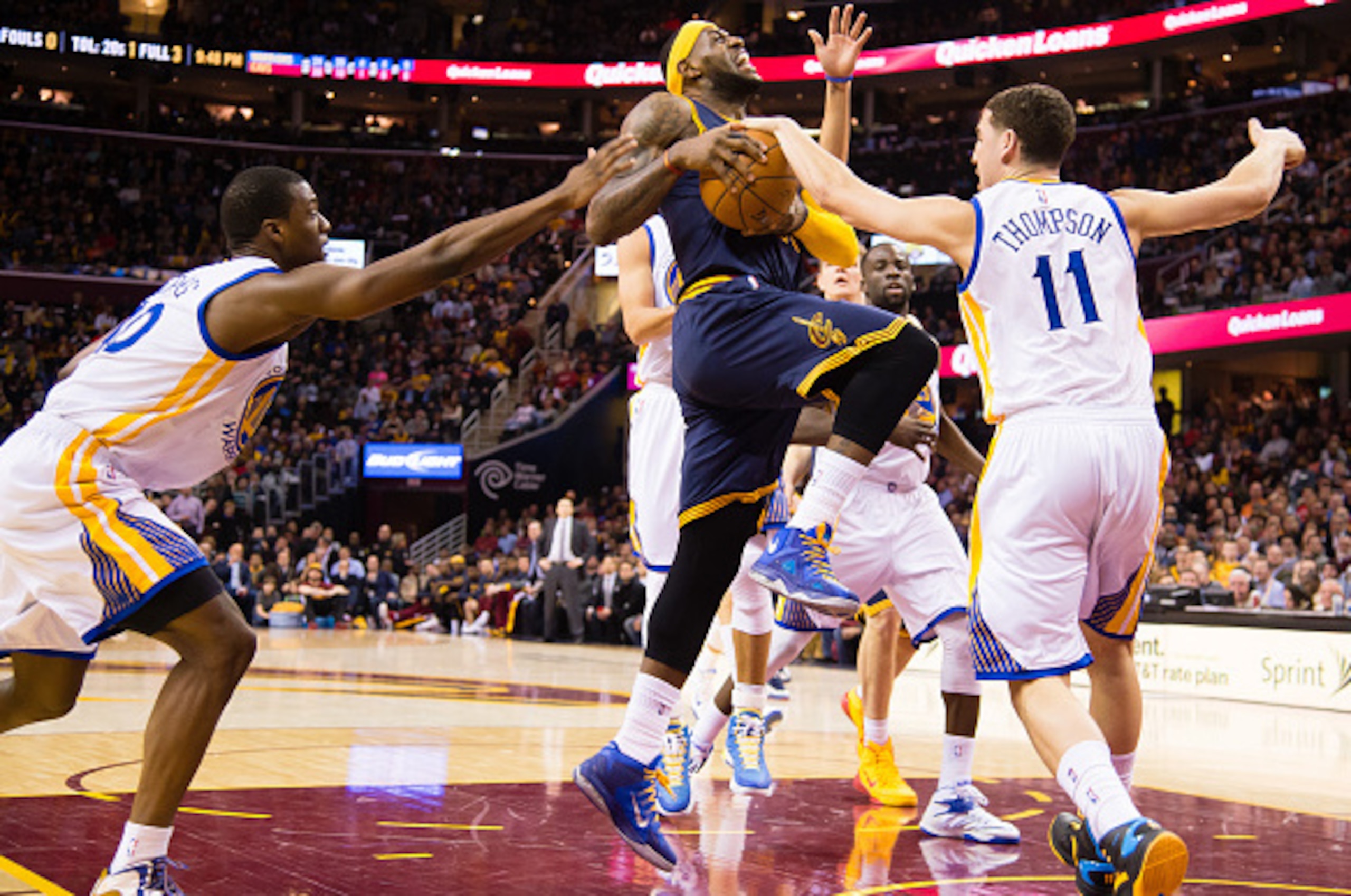 zCLEVELAND, OH - FEBRUARY 26: Harrison Barnes #40 and Klay Thompson #11 of the Golden State Warriors try to stop LeBron James #23 of the Cleveland Cavaliers during the second half at Quicken Loans Arena on February 26, 2015 in Cleveland, Ohio. The Cavalie