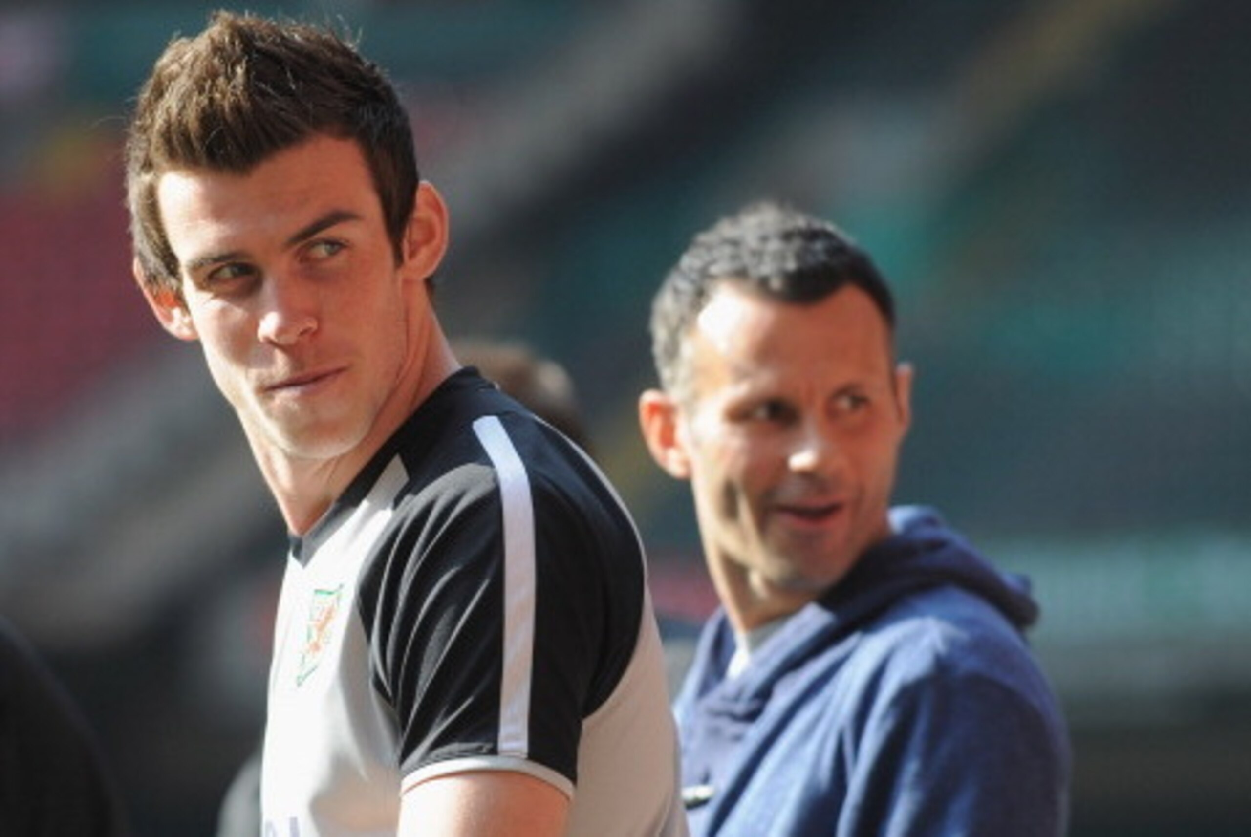 CARDIFF, WALES - MARCH 25:  Gareth Bale looks on as he sits out with an injury with Ryan Giggs during the Wales training session ahead of their UEFA EURO 2012 qualifier against England on March 25, 2011 in Cardiff, Wales.  (Photo by Michael Regan/Getty Im