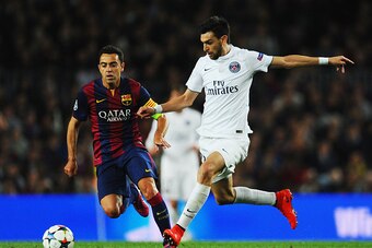 BARCELONA, SPAIN - APRIL 21:  Javier Pastore is watched by Xavi of Barcelona during the UEFA Champions League Quarter Final second leg match between FC Barcelona and Paris Saint-Germain at Camp Nou on April 21, 2015 in Barcelona, Spain.  (Photo by David R