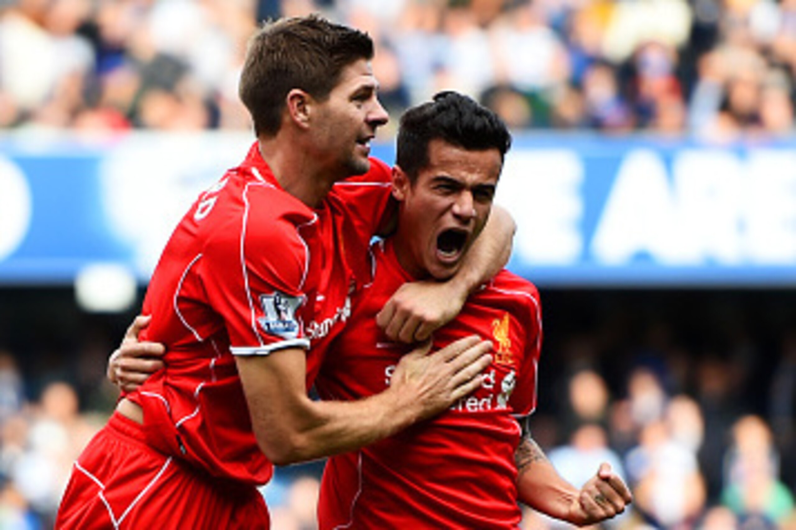 LONDON, ENGLAND - OCTOBER 19:  Philippe Coutinho of Liverpool celebrates with team-mate Steven Gerrard after scoring his team's second goal during the Barclays Premier League match between Queens Park Rangers and Liverpool at Loftus Road on October 19, 20