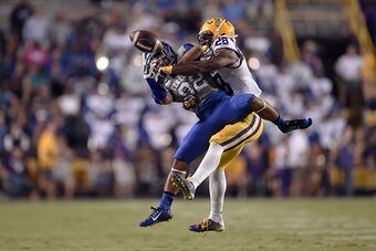 BATON ROUGE, LA - OCTOBER 18:  Jalen Mills #28 of the LSU Tigers defends a pass intended for T.V. Williams #82 of the Kentucky Wildcats during the fourth quarter of a game at Tiger Stadium on October 18, 2014 in Baton Rouge, Louisiana.  LSU won the game 4