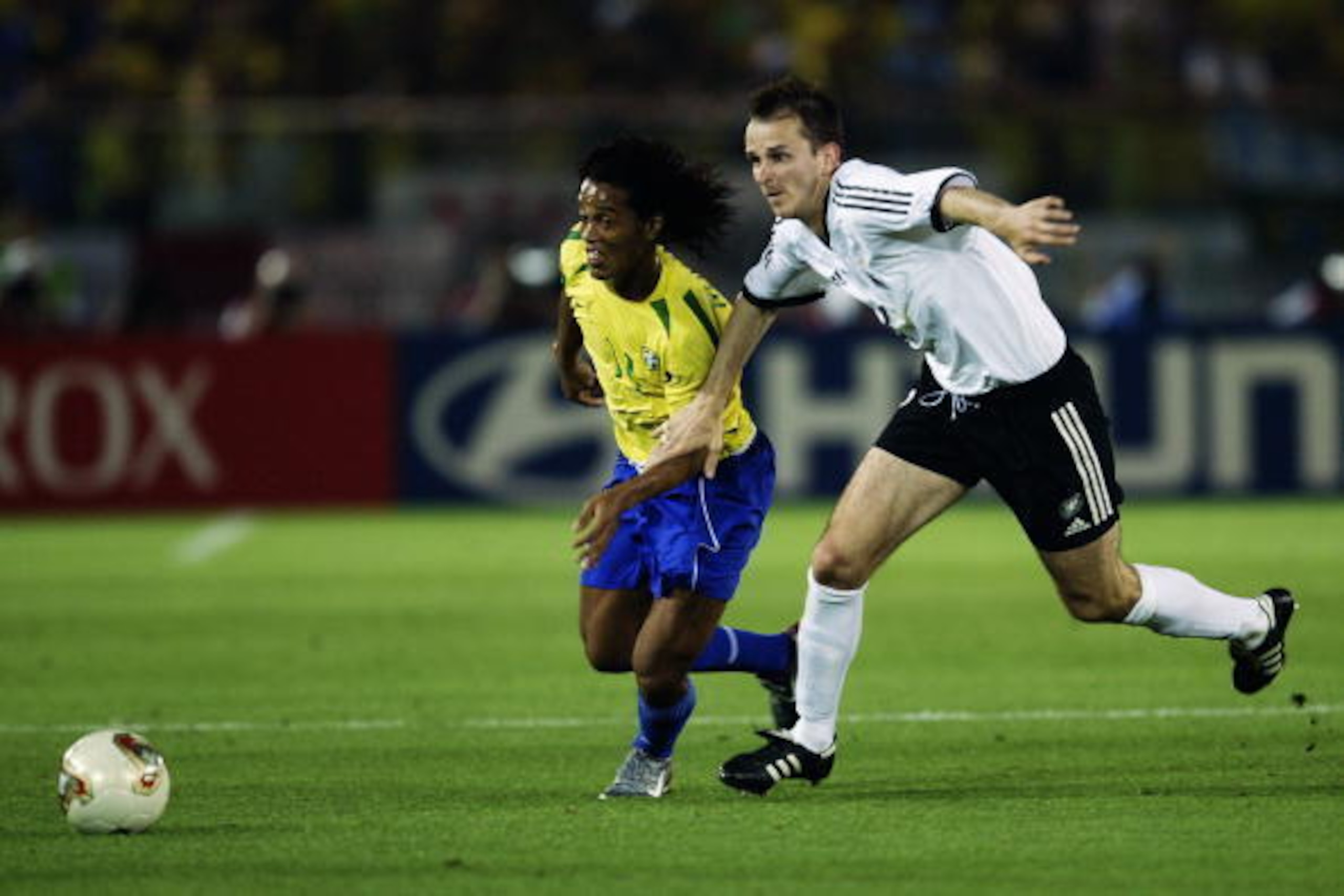 YOKOHAMA - JUNE 30:  Ronaldinho of Brazil takes on Dietmar Hamann of Germany during the Germany v Brazil, World Cup Final match played at the International Stadium Yokohama in Yokohama, Japan on June 30, 2002. Brazil won 2-0. (Photo by David Cannon/Getty 