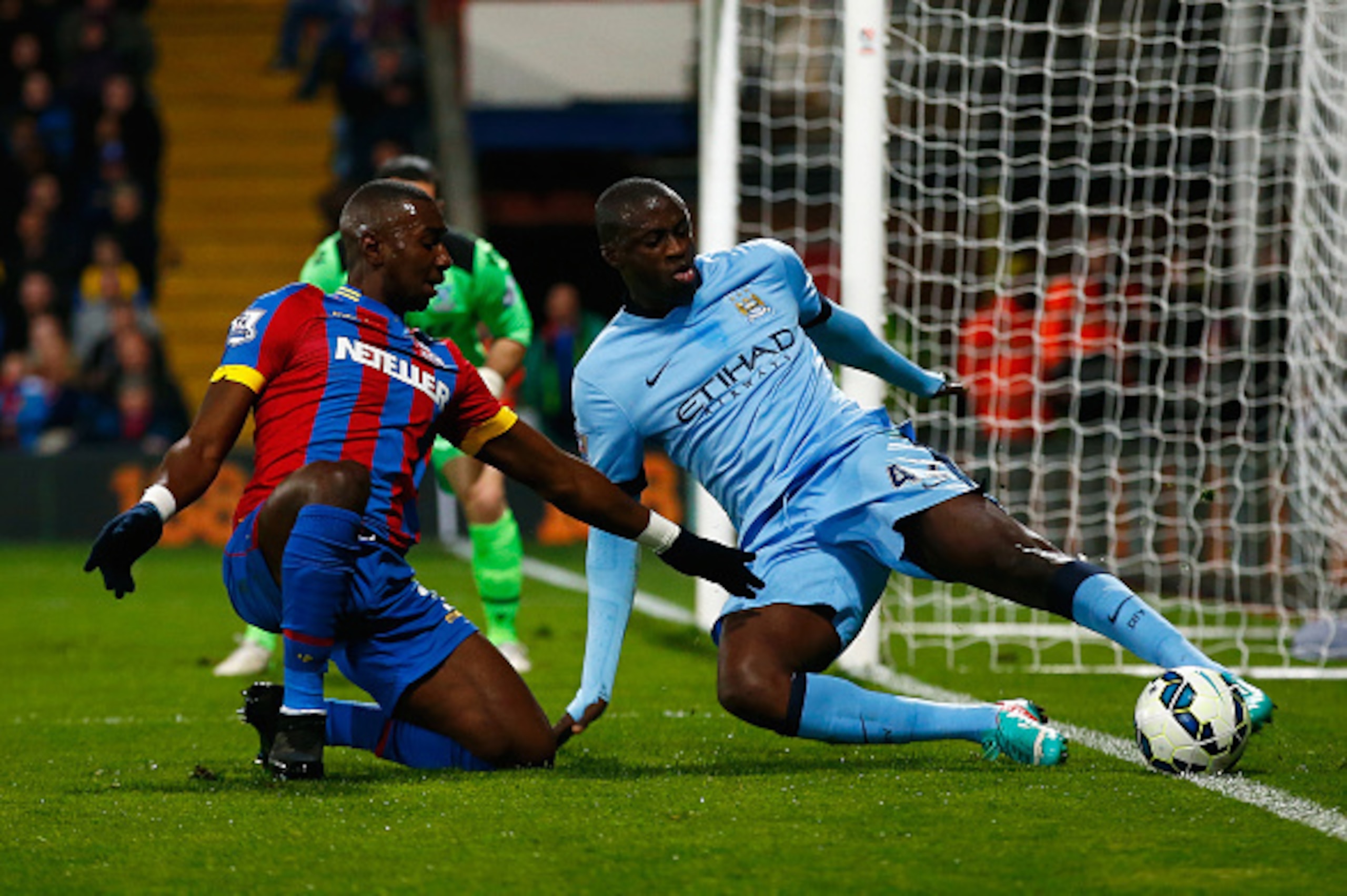 LONDON, ENGLAND - APRIL 06: Yaya Toure of Manchester City tries to keep the ball in play as he is challenged by Yannick Bolasie of Crystal Palace during the Barclays Premier League match between Crystal Palace and Manchester City at Selhurst Park on April