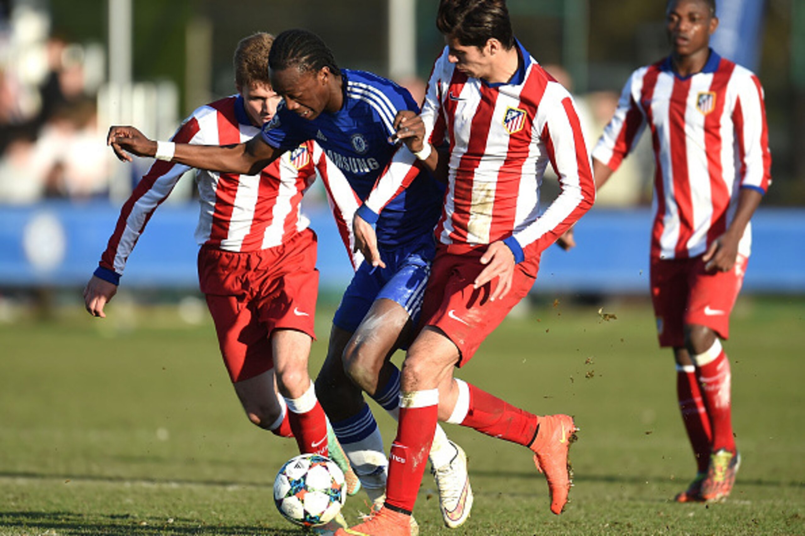 COBHAM, ENGLAND - MARCH 10:  Tammy Abraham of Chelsea together with Fran Manzanara (L) and Saeid Ezatolahi (R) of Atletico Madrid battle for the ball during the UEFA Youth League Quarter Final match between Chelsea and Atletico Madrid at Chelsea Training 