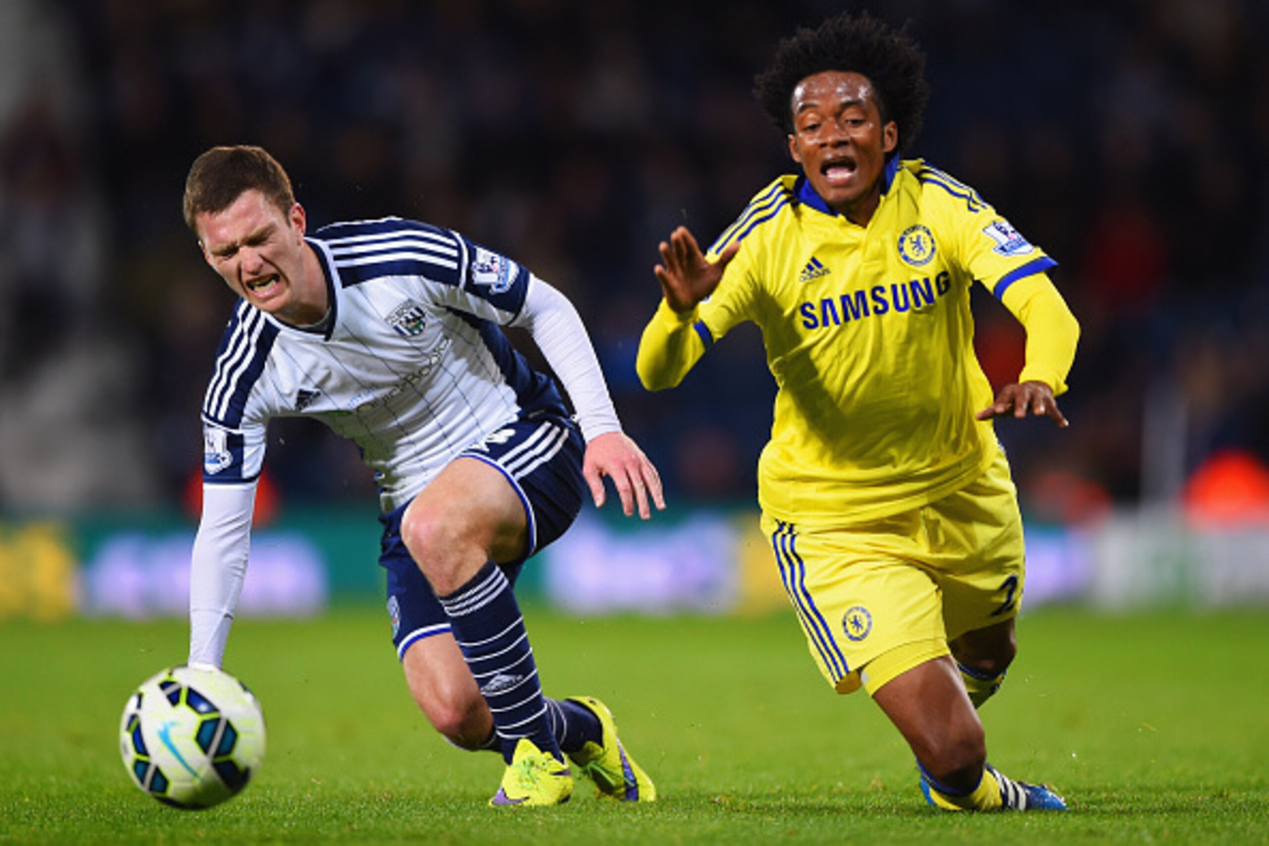 WEST BROMWICH, ENGLAND - MAY 18:  Craig Gardner of West Bromwich Albion and Juan Cuadrado of Chelsea stumble as they battle for the ball during the Barclays Premier League match between West Bromwich Albion and Chelsea at The Hawthorns on May 18, 2015 in 