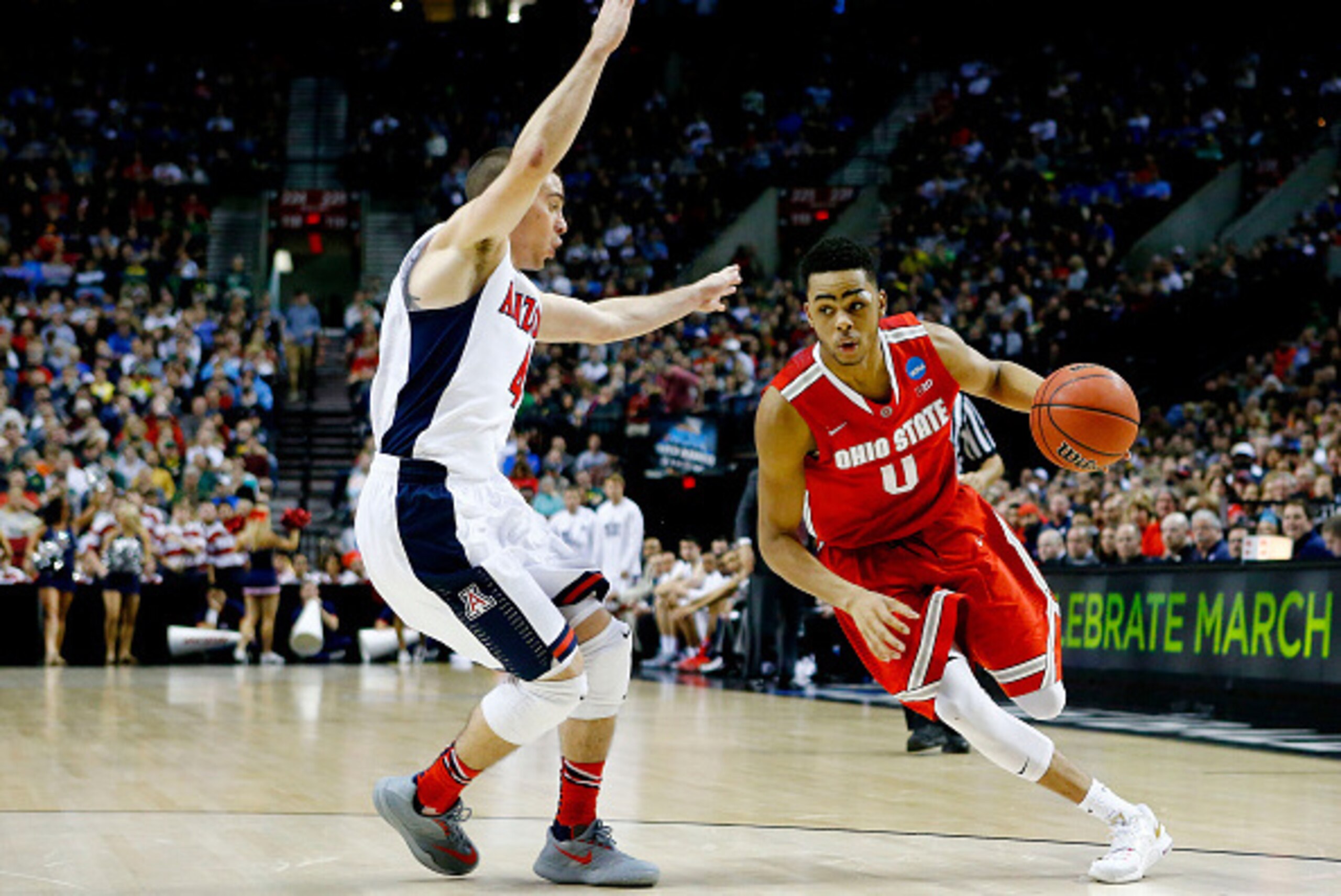 PORTLAND, OR - MARCH 21:  D'Angelo Russell #0 of the Ohio State Buckeyes drives against T.J. McConnell #4 of the Arizona Wildcats in the second half during the third round of the 2015 NCAA Men's Basketball Tournament at Moda Center on March 21, 2015 in Po