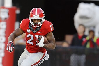 ATHENS, GA - OCTOBER 04:  Running back Nick Chubb #27 of the Georgia Bulldogs runs past cornerback Taurean Ferguson #3 of the Vanderbilt Commodores during the game at Sanford Stadium on October 4, 2014 in Athens, Georgia.  (Photo by Mike Zarrilli/Getty Im