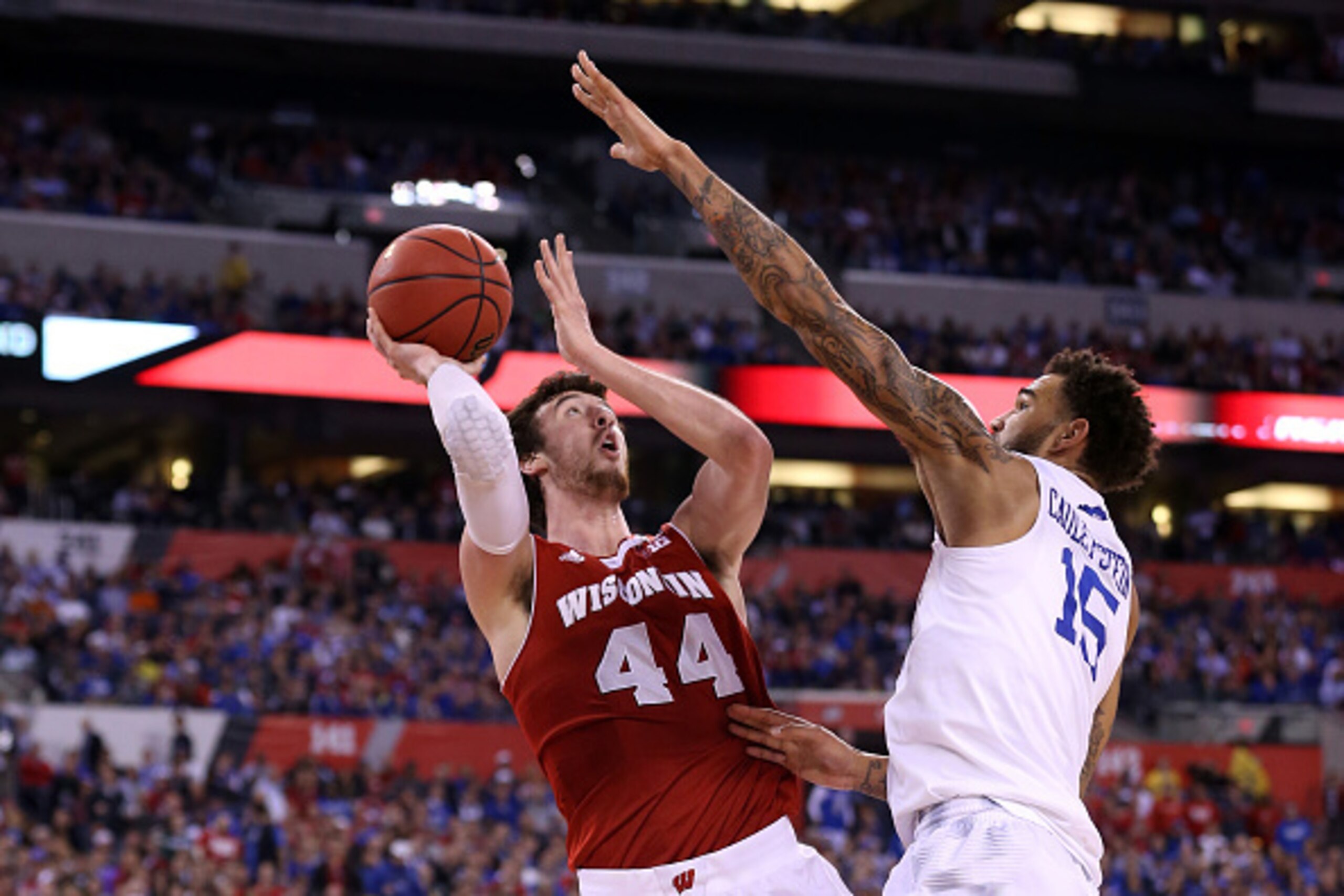 INDIANAPOLIS, IN - APRIL 04: Frank Kaminsky #44 of the Wisconsin Badgers shoots against Willie Cauley-Stein #15 of the Kentucky Wildcats in the second half during the NCAA Men's Final Four Semifinal at Lucas Oil Stadium on April 4, 2015 in Indianapolis, I