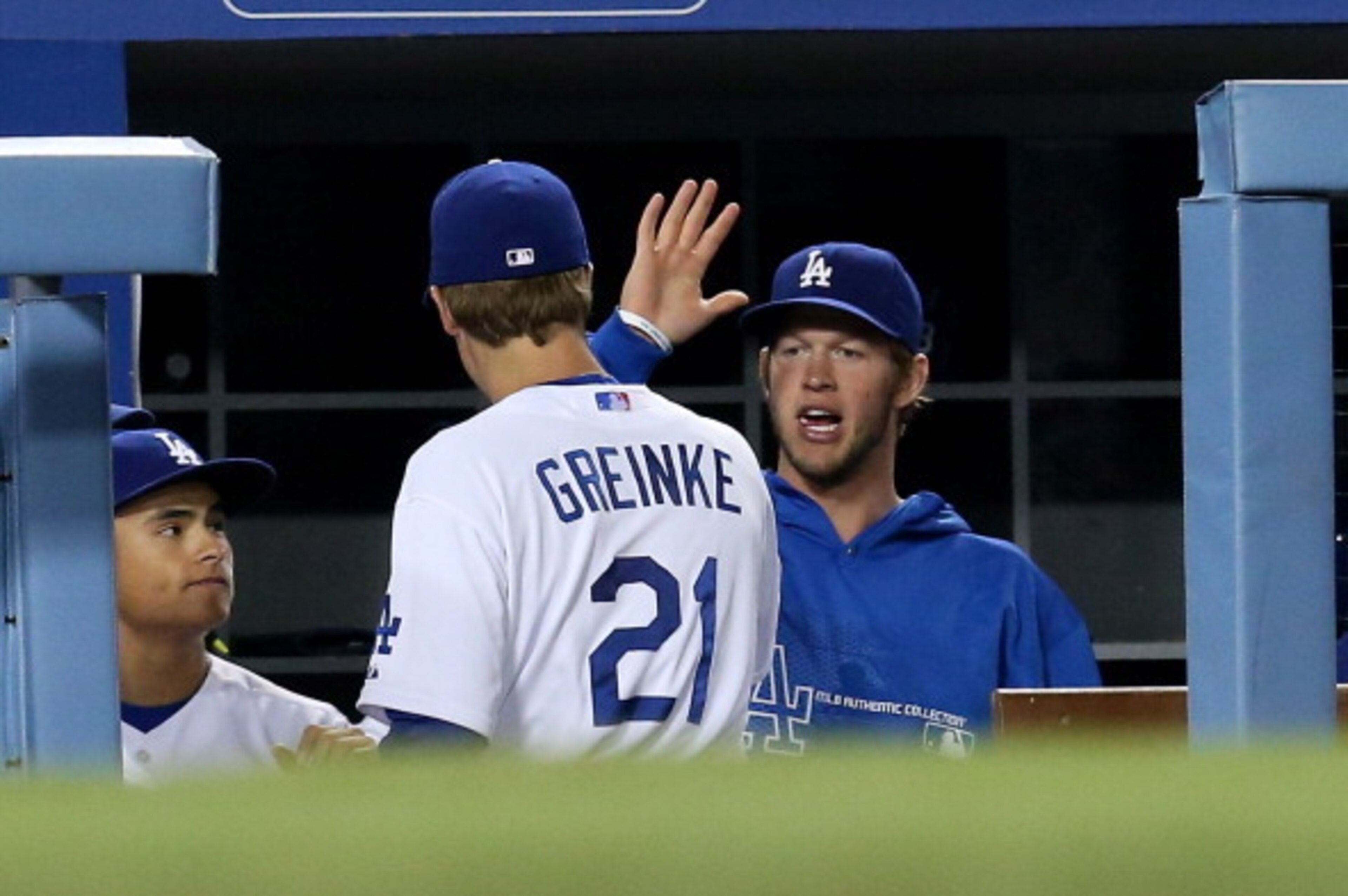 LOS ANGELES, CA - MAY 15:  Zack Greinke #21 of the Los Angeles Dodgers is greeted in the dugout by Clayton Kershaw#22 after being relieved in the sixth inning of the game against the Washington Nationals at Dodger Stadium on May 15, 2013 in Los Angeles, C