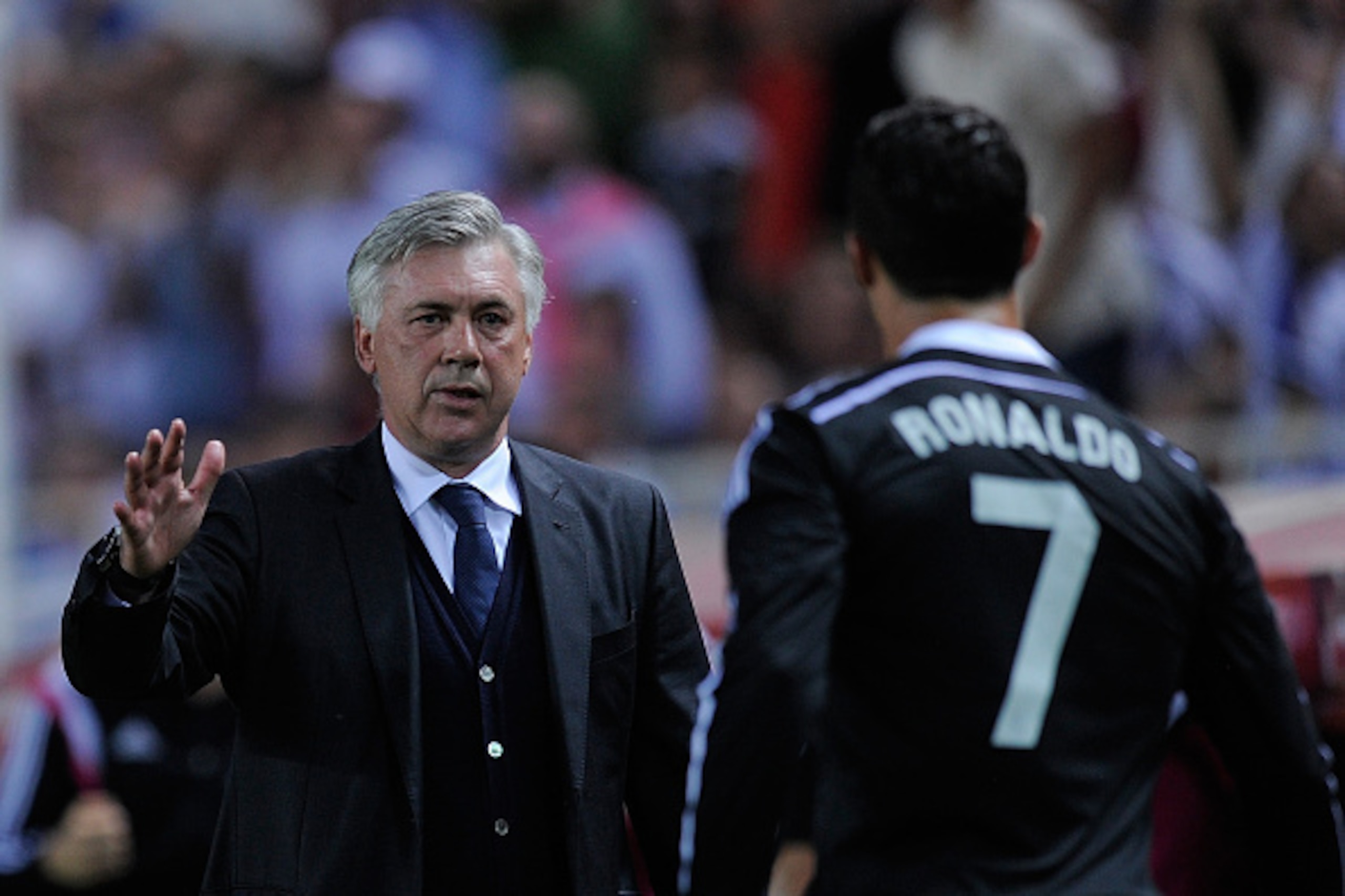 SEVILLE, SPAIN - MAY 02:  Head coach Carlo Ancelotti of Real Madrid congratulated Cristiano Ronaldo after Ronaldo scored his team's 3rd goal during the La Liga match between Sevilla FC and Real Madrid CF at Estadio Ramon Sanchez Pizjuan on May 2, 2015 in 