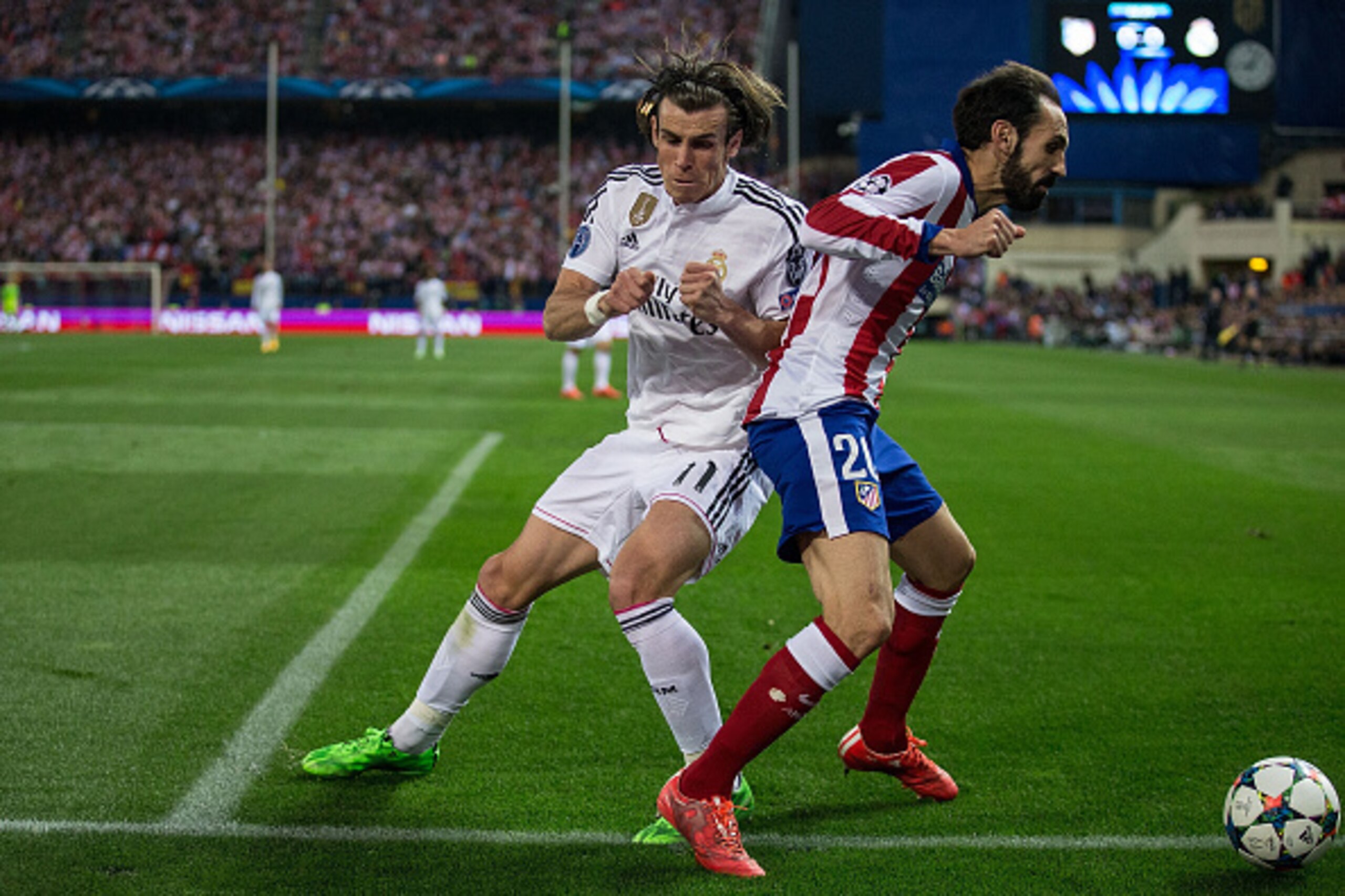 MADRID, SPAIN - APRIL 14:  Gareth Bale (L) of Real Madrid CF tackles Juan Francisco Torres alias Juanfran (R) of Atletico de Madrid during the UEFA Champions League Quarter Final First Leg match between Club Atletico de Madrid and Real Madrid CF at Vicent
