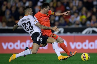 VALENCIA, SPAIN - NOVEMBER 30: Lionel Messi (R) of FC Barcelona competes for the ball with Nicolas Otamendi (L) of Valencia CF during the La Liga match between Valencia CF and FC Barcelona at Estadi de Mestalla on November 30, 2014 in Valencia, Spain.  (P