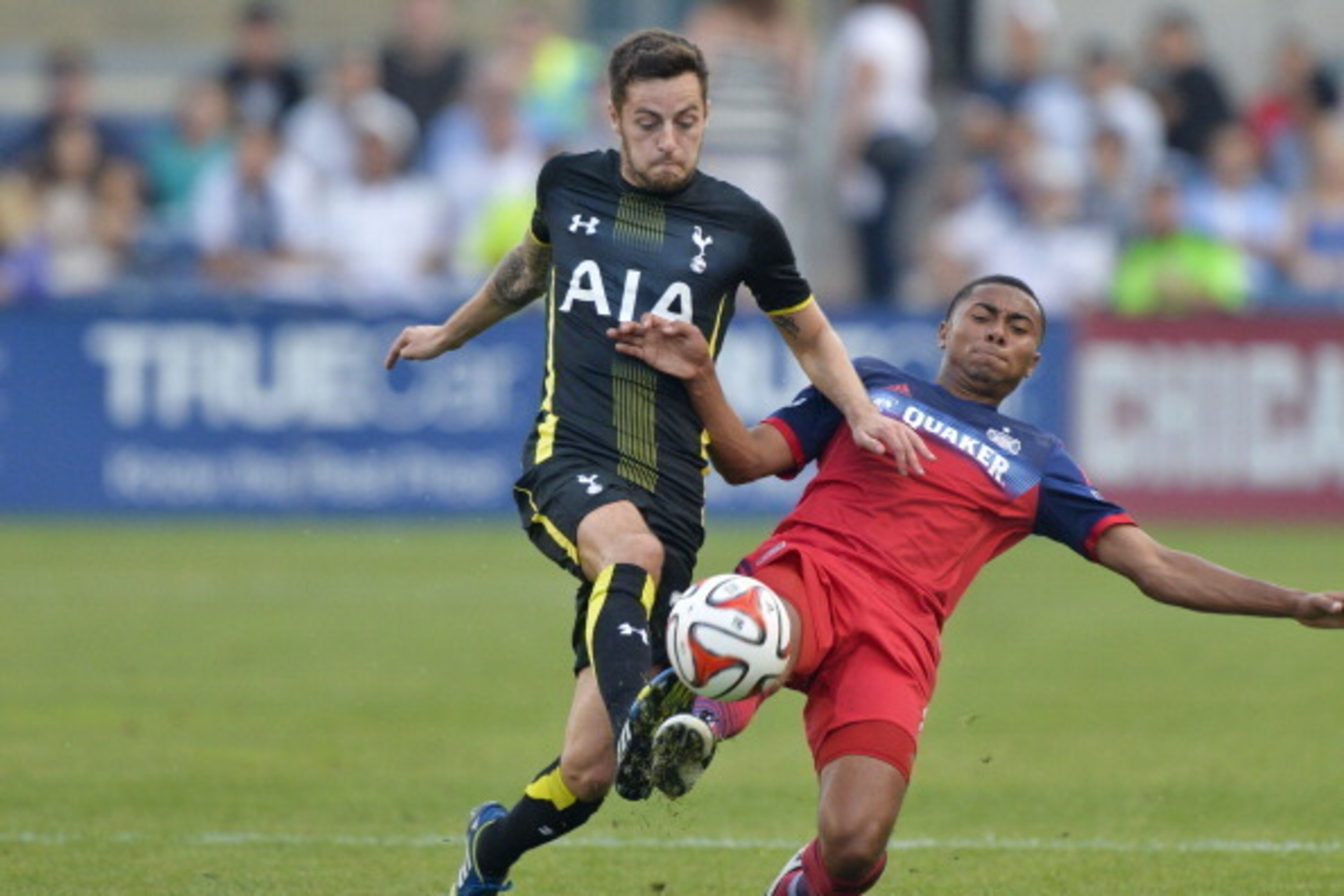 BRIDGEVIEW, IL - JULY 26:  Ryan Mason #38 of Tottenham Hotspur (L) and Grant Ward #8 of Chicago Fire go for the ball during the first half at Toyota Park on July 26, 2014 in Bridgeview, Illinois.  (Photo by Brian Kersey/Getty Images)