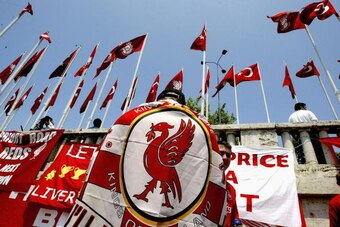 ISTANBUL, TURKEY - MAY 25: A supporter of Liverpool FC is seen with a flag draped over their shoulders in Taxim Square before the Champions League final on May 25, 2005 in Istanbul, Turkey.  A massive security operatin has been mounted by Turkish police t