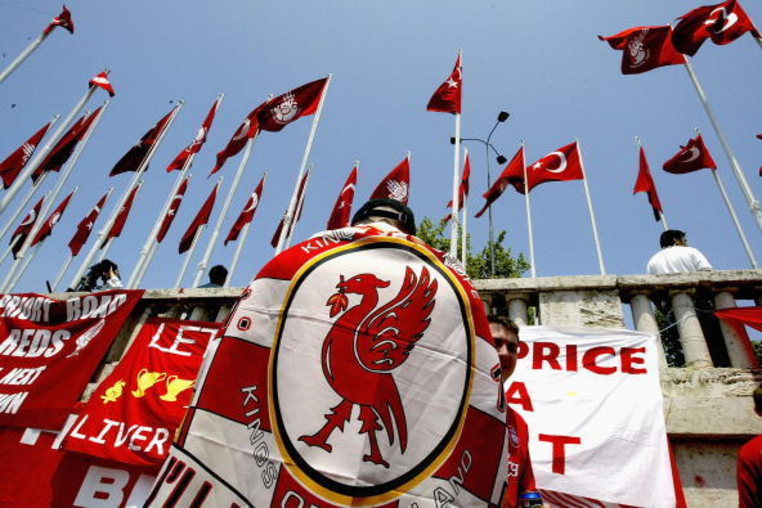 ISTANBUL, TURKEY - MAY 25: A supporter of Liverpool FC is seen with a flag draped over their shoulders in Taxim Square before the Champions League final on May 25, 2005 in Istanbul, Turkey.  A massive security operatin has been mounted by Turkish police t