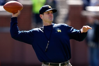 ANN ARBOR, MI - APRIL 04: Head coach Jim Harbaugh of the Michigan Wolverines throws a football during the Michigan Football Spring Game on April 4, 2015 at Michigan Stadium in Ann Arbor, Michigan.  (Photo by Gregory Shamus/Getty Images)