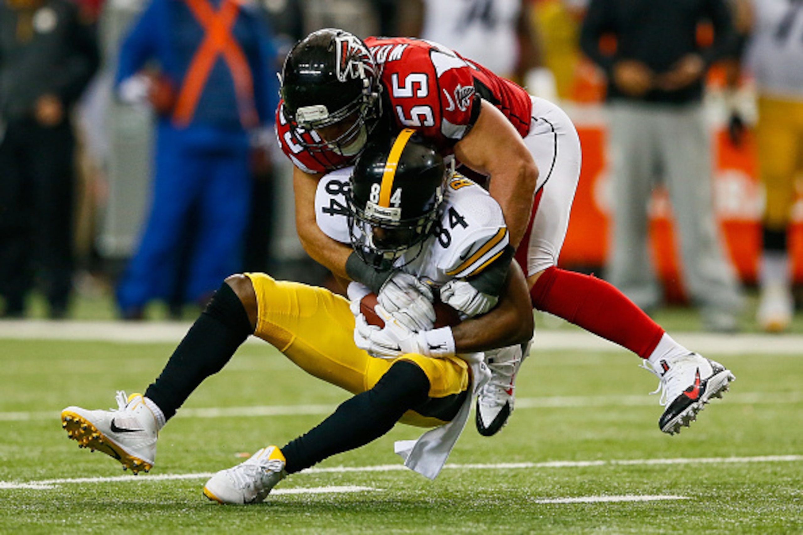 ATLANTA, GA - DECEMBER 14: Antonio Brown #84 of the Pittsburgh Steelers is tackled after a reception by Paul Worrilow #55 of the Atlanta Falcons in the second half at the Georgia Dome on December 14, 2014 in Atlanta, Georgia.  (Photo by Kevin C. Cox/Getty