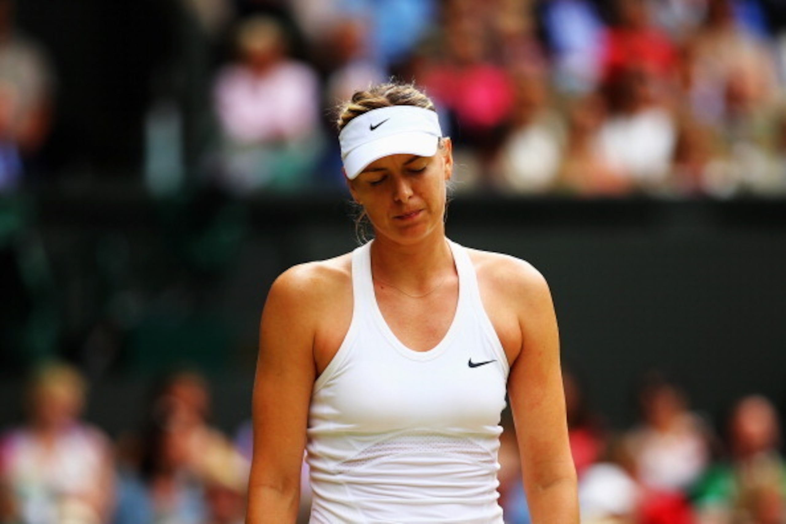 LONDON, ENGLAND - JULY 01:  Maria Sharapova of Russia stands dejected during her Ladies' Singles fourth round match against Angelique Kerber of Germany on day eight of the Wimbledon Lawn Tennis Championships at the All England Lawn Tennis and Croquet Club