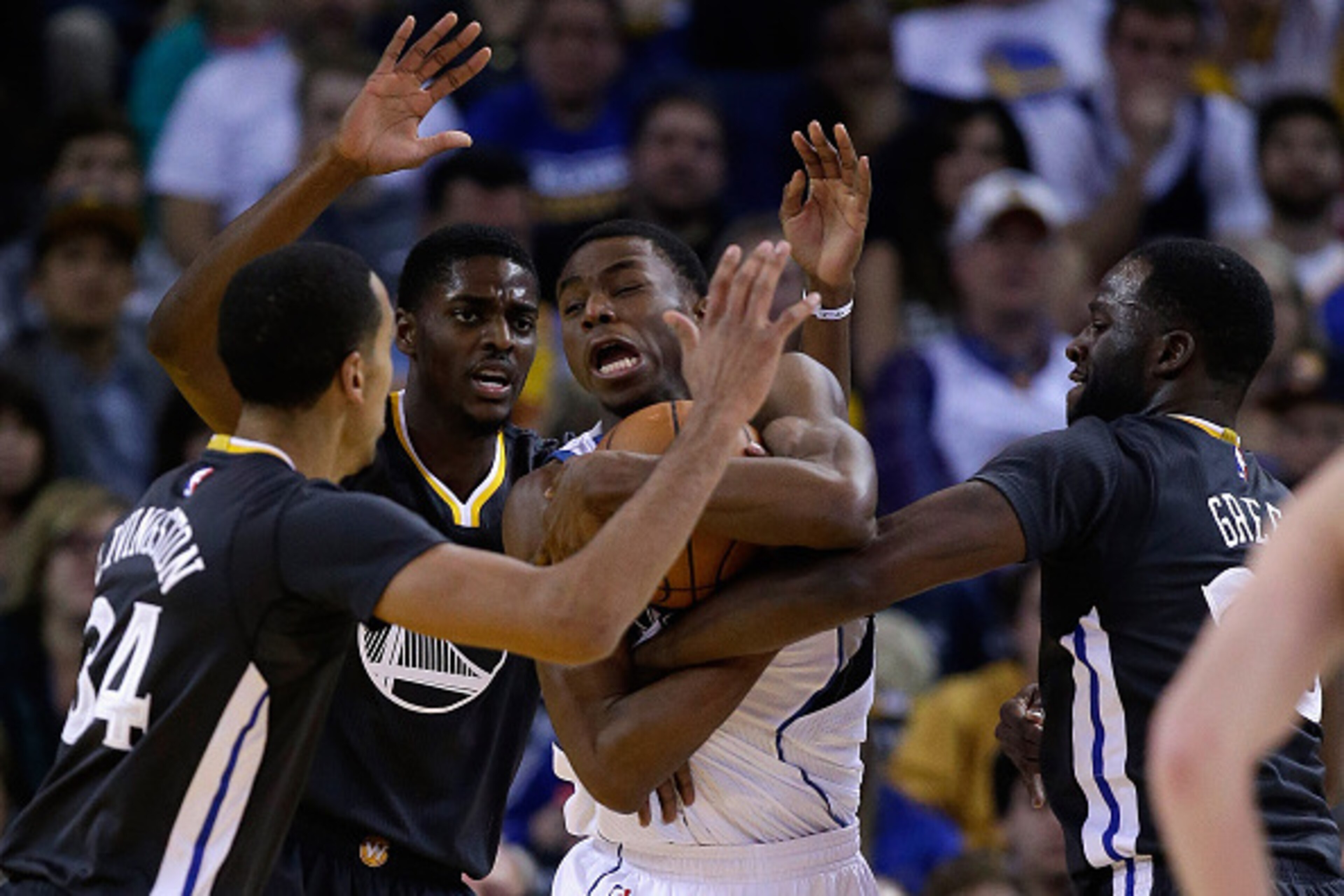 OAKLAND, CA - DECEMBER 27:  Andrew Wiggins #22 of the Minnesota Timberwolves is surrounded by Justin Holiday #7, Shaun Livingston #34 and Draymond Green #23 of the Golden State Warriors at ORACLE Arena on December 27, 2014 in Oakland, California.  NOTE TO